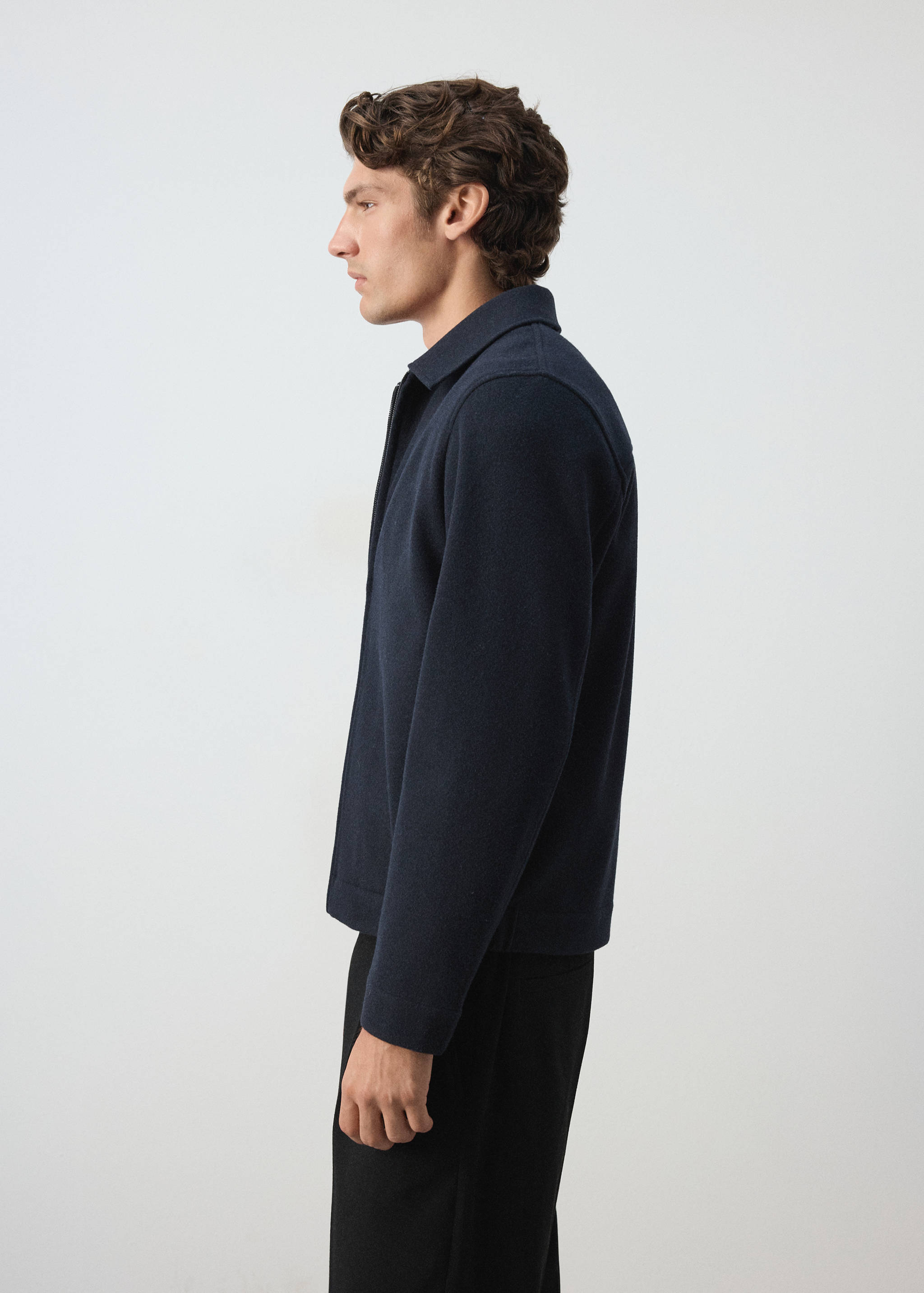 Dark navy blue sweatshirt with a collar and zip-up front, shown in profile.