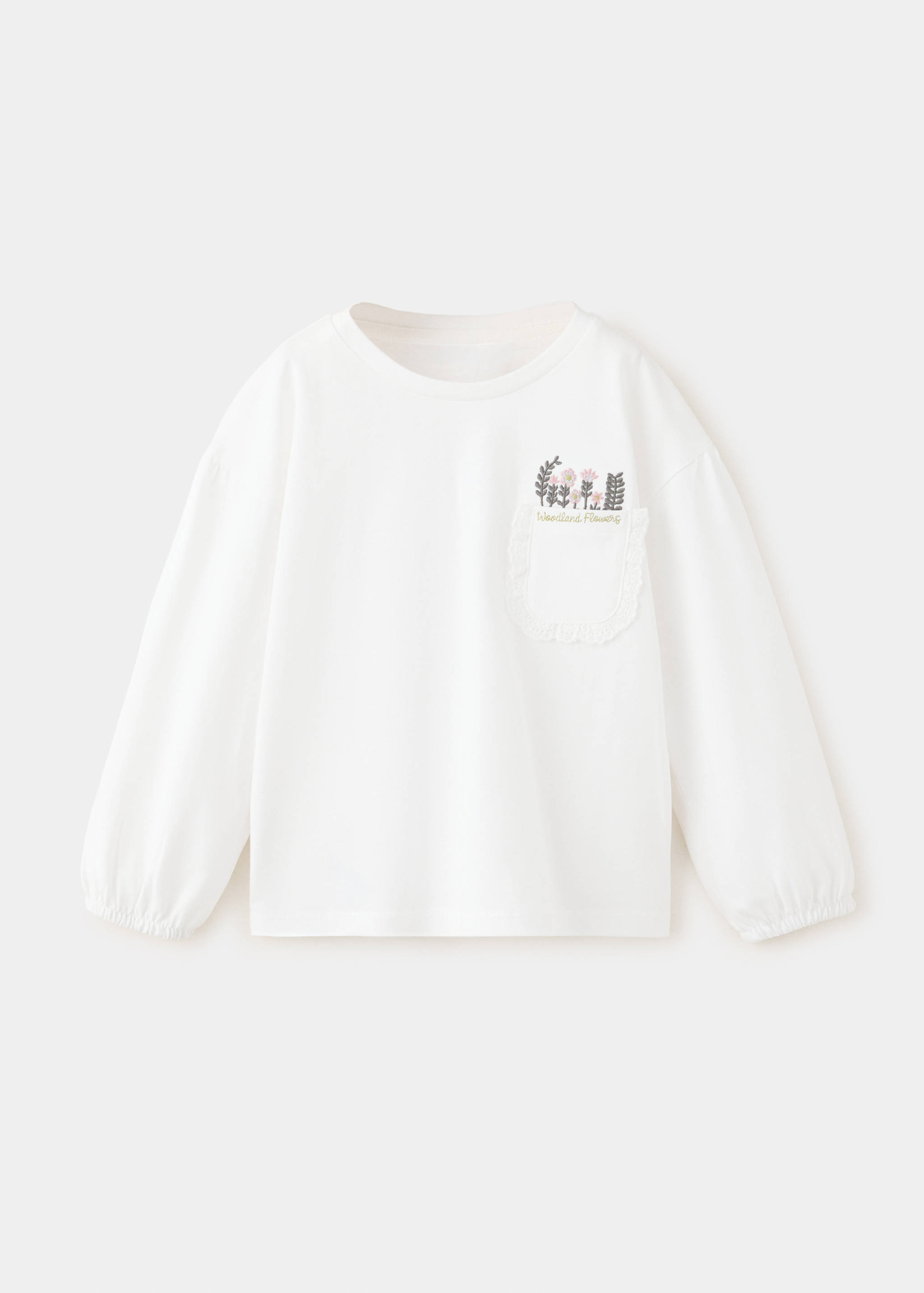 White long-sleeved t-shirt with a floral embroidered chest pocket.