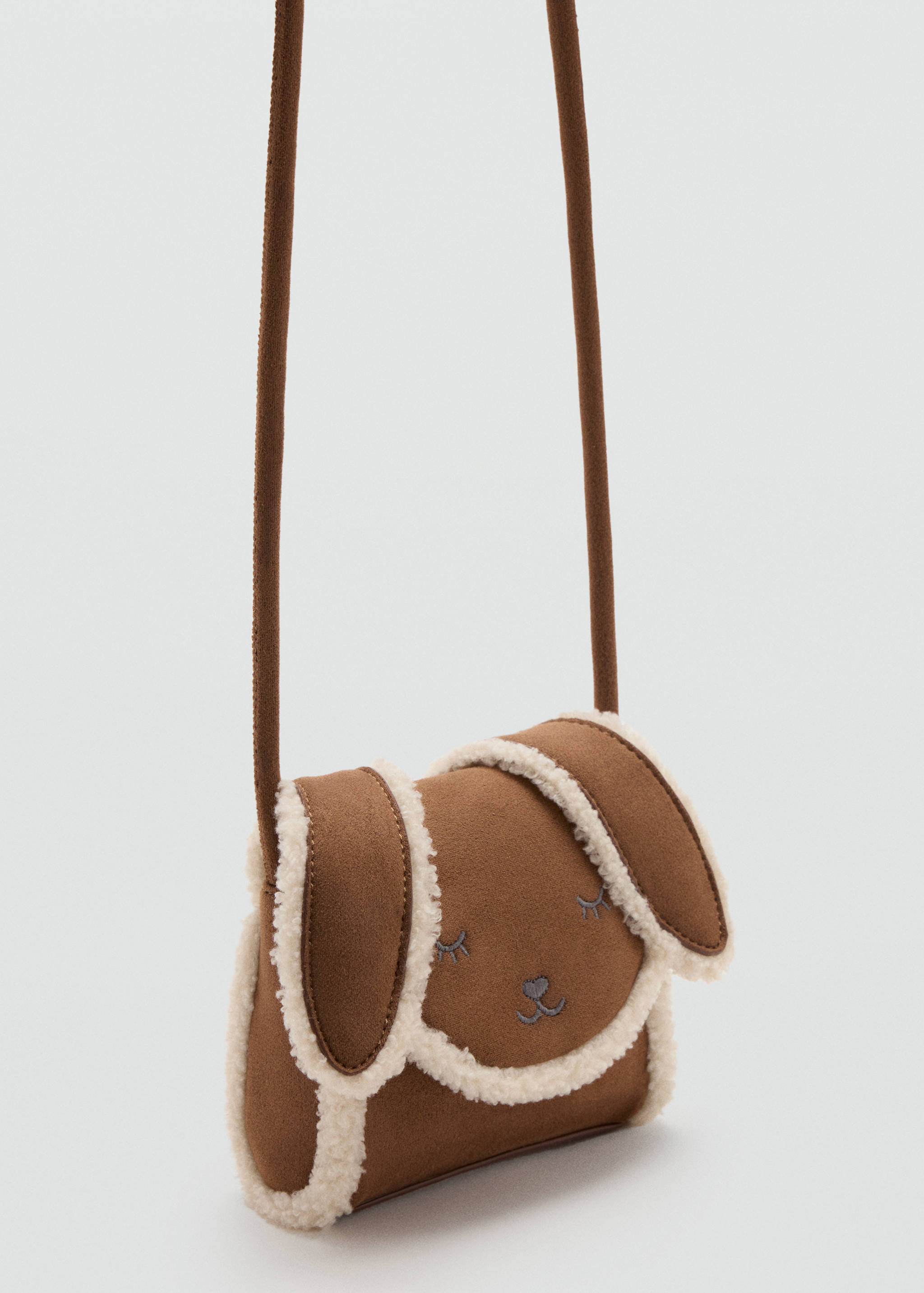 Minibolso bandolera infantil marrón con ribete de borreguillo y bordado de cara de animal.