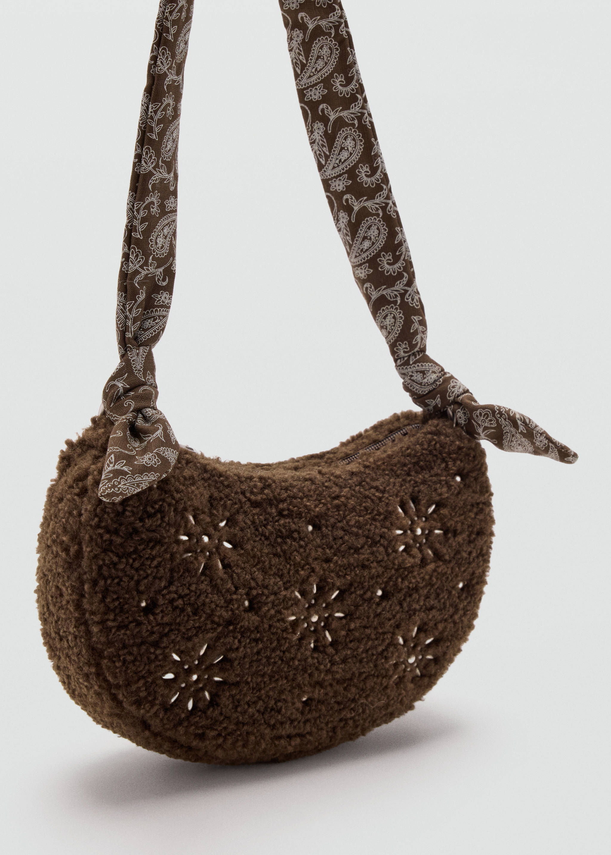 Brown faux-fur mini shoulder bag with white embroidery and a paisley strap.