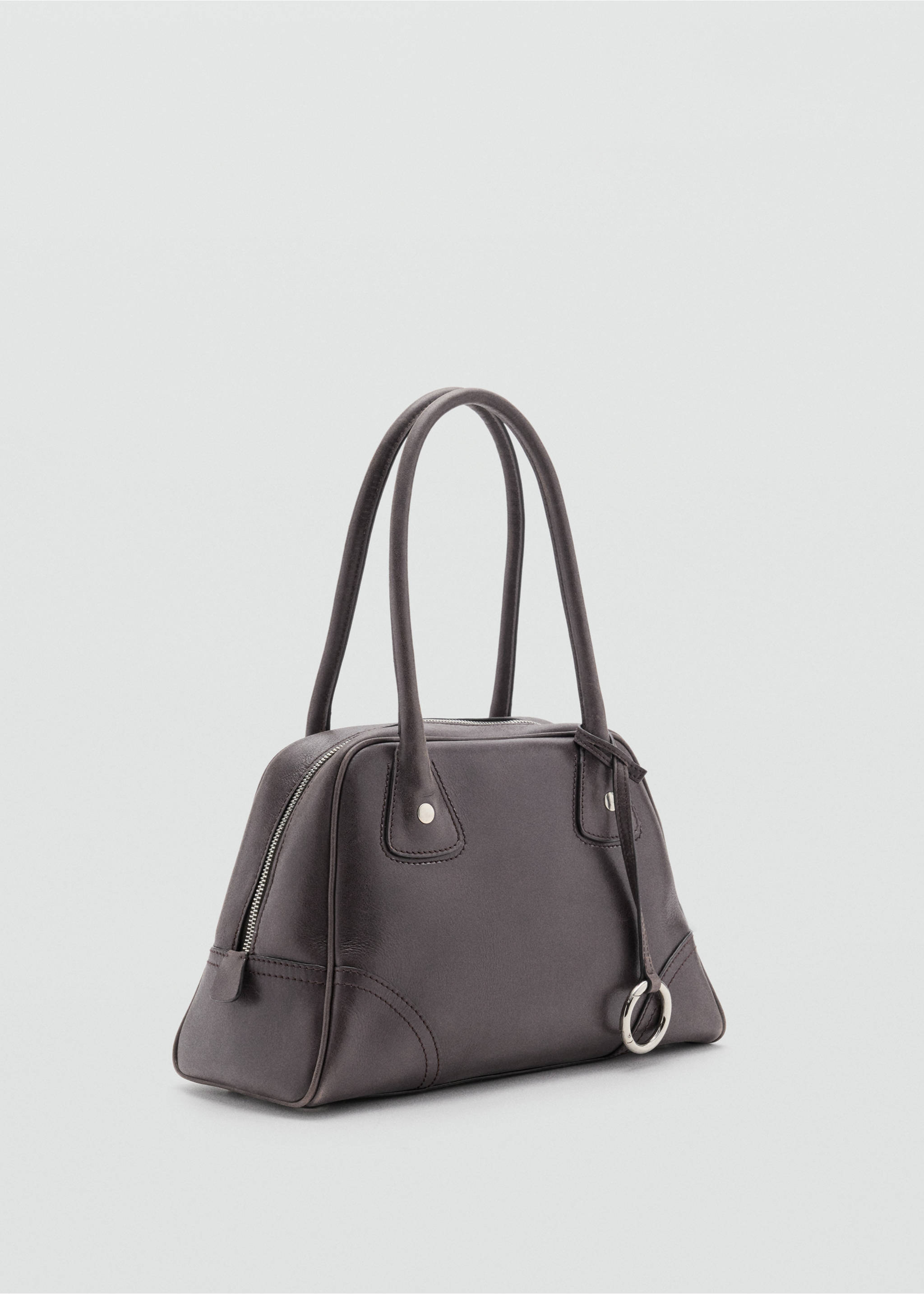 Dark brown bowling bag with top handles, zip closure, and circular silver ring charm., Chocolate. Ref: 37007943-00.