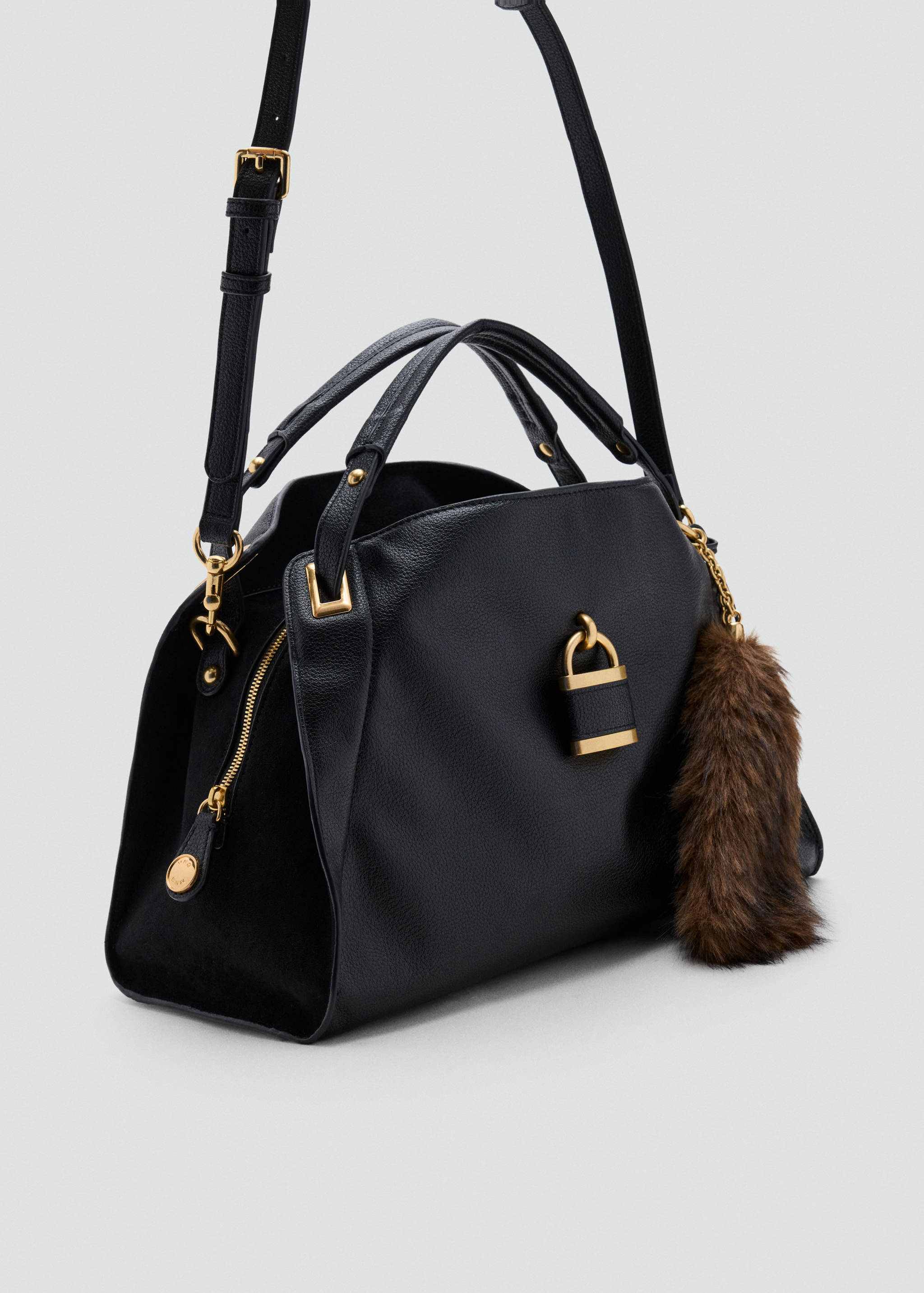 Black shoulder bag with gold-tone hardware, padlock detail, and a brown faux-fur charm.