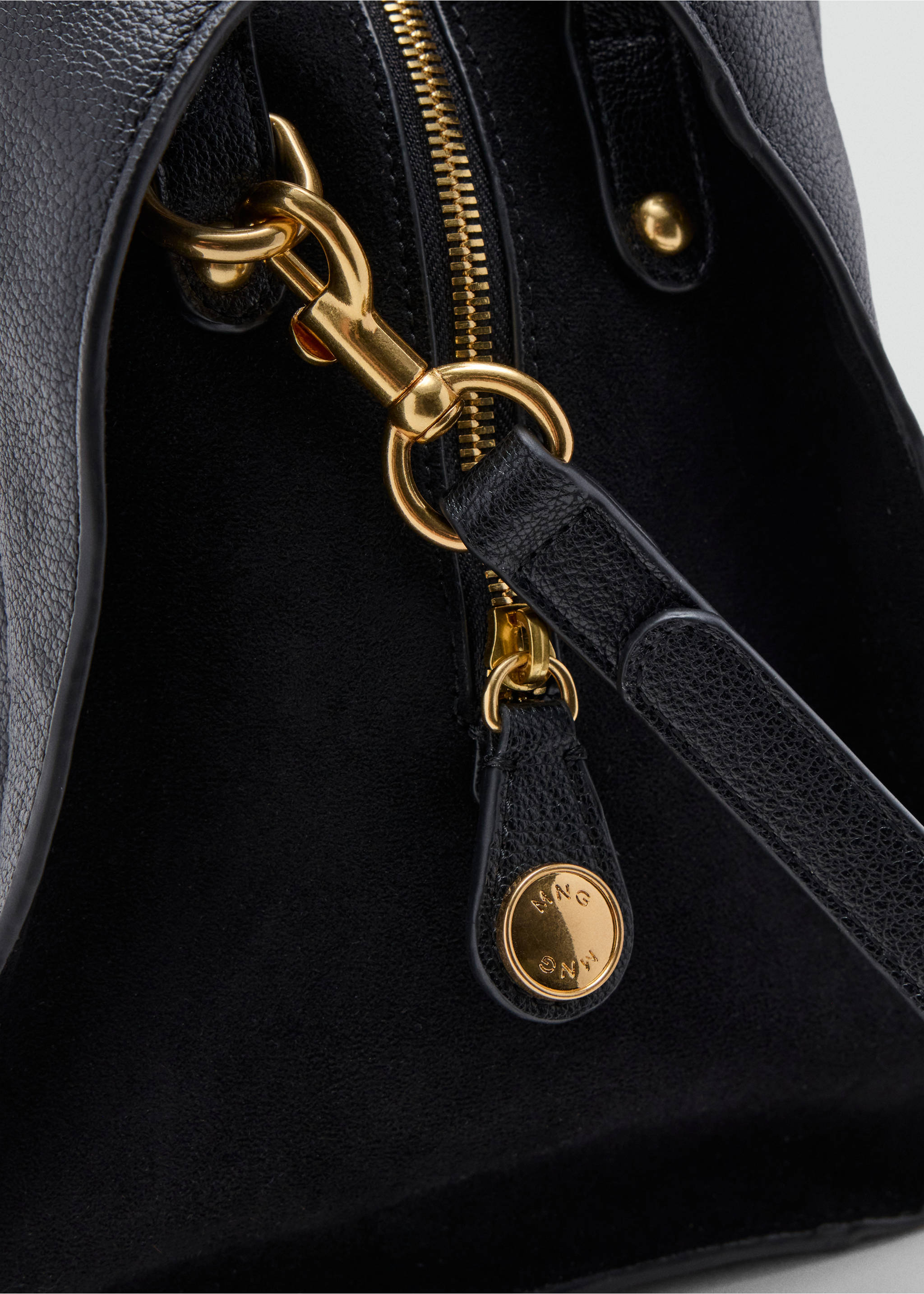 Close-up of a black shoulder bag featuring gold-toned hardware and a zip fastening., Black. Ref: 37007945-00.