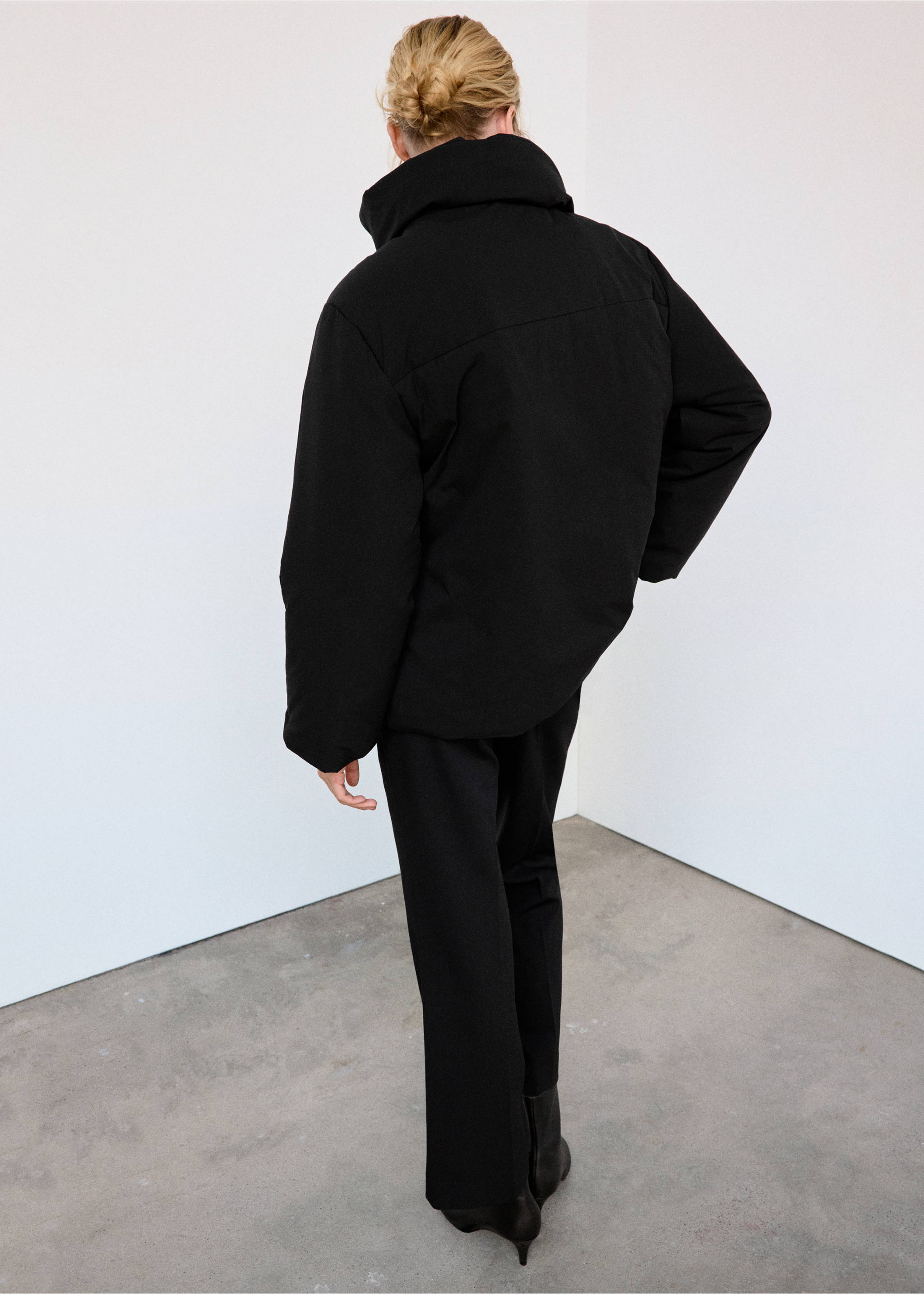 Black anorak with a high collar, shown from the back., Black. Ref: 37008272-01.