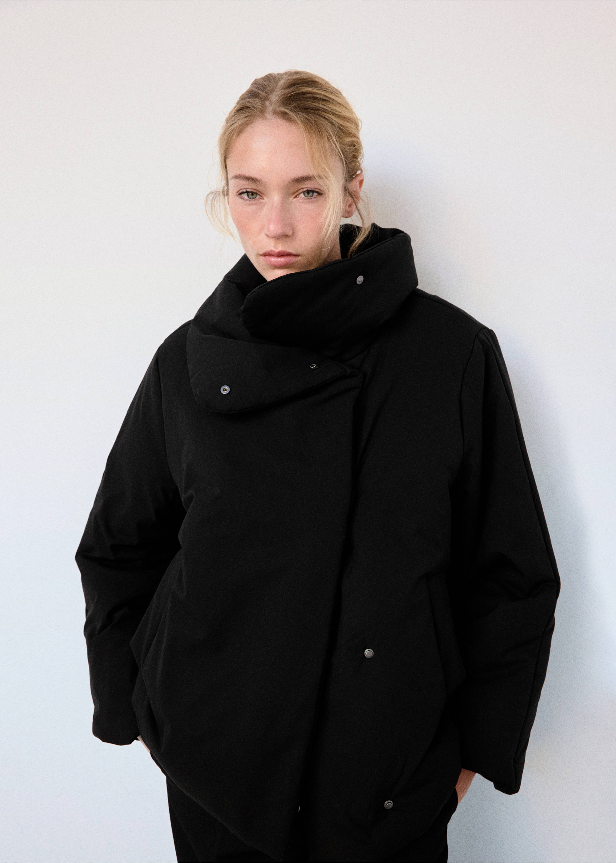 Black anorak with a high wrap collar and snap-button closure., Black. Ref: 37008272-01.