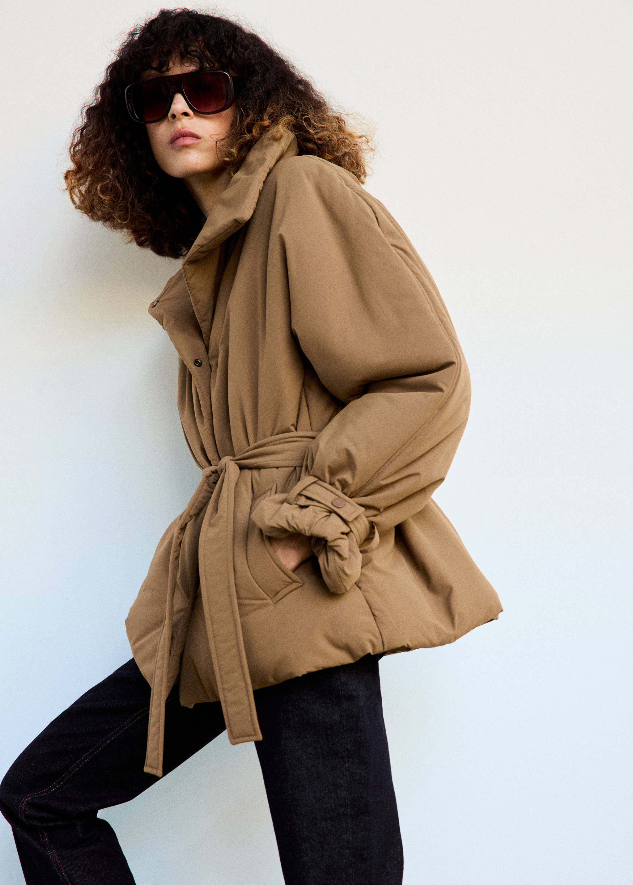Brown anorak jacket with a high collar and self-tie belt.