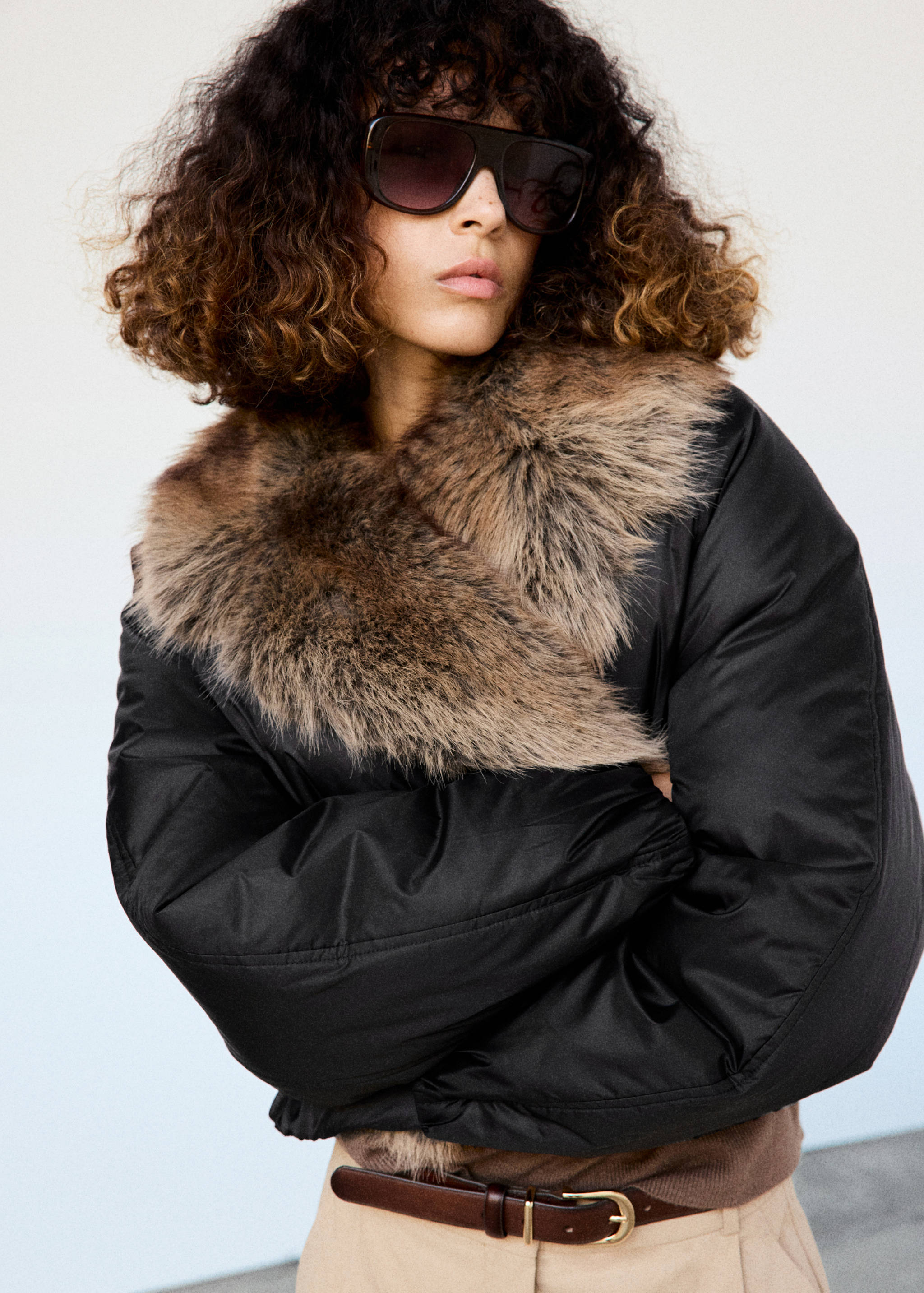 Black cropped anorak with a brown faux-fur lapel collar.
