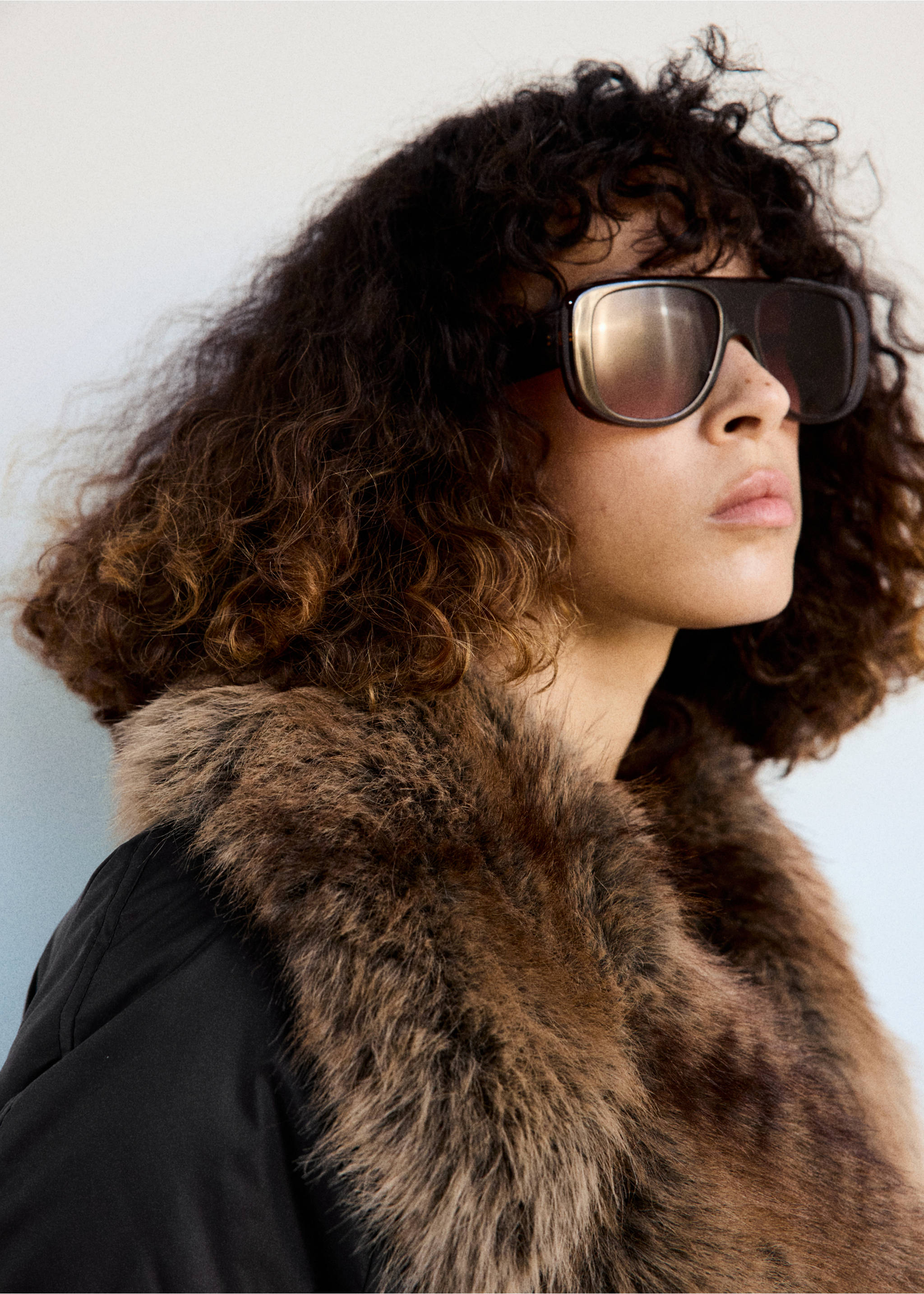 Close-up of a dark anorak featuring a wide brown faux-fur collar., Black. Ref: 37008274-00.