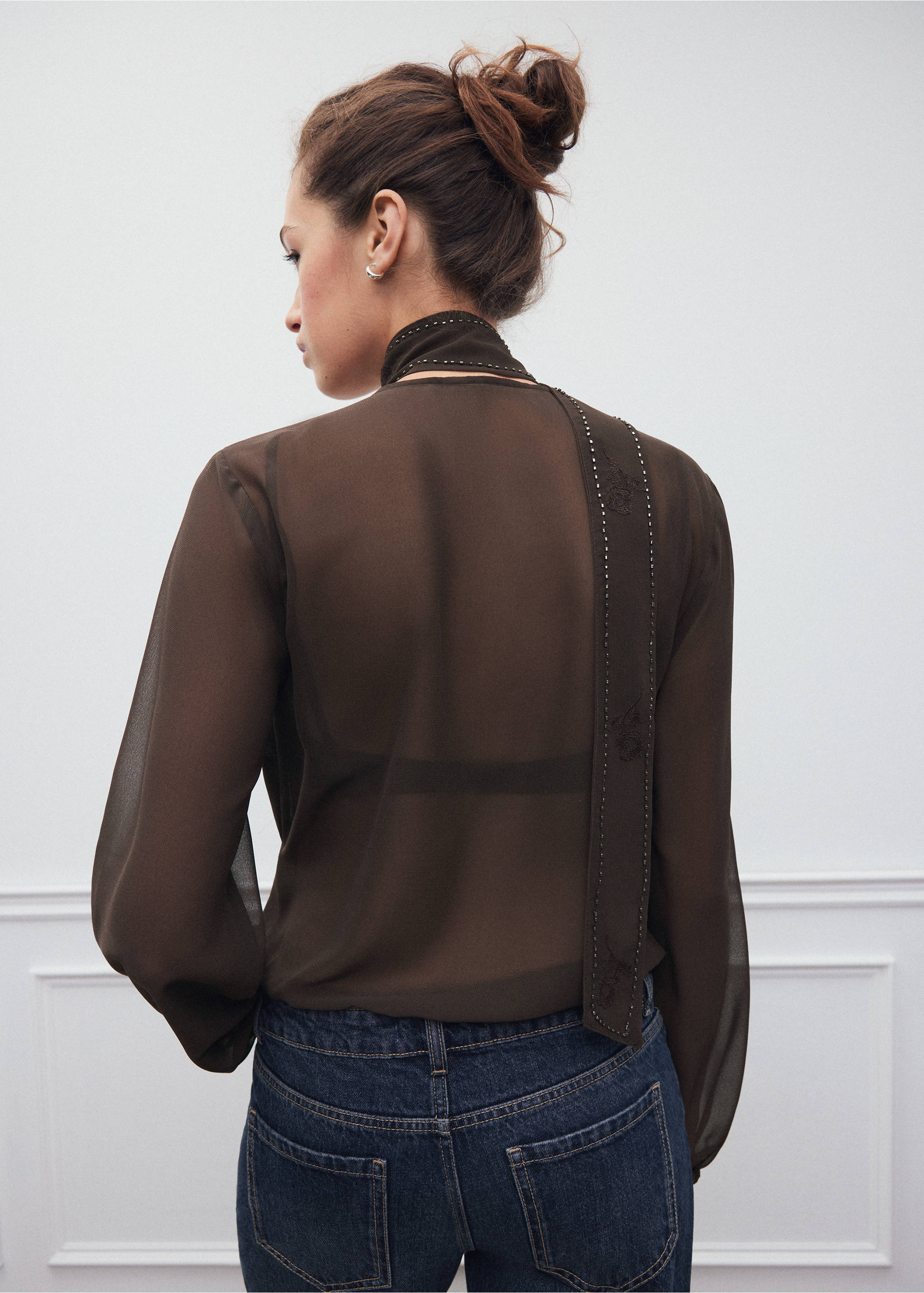 Back view of a dark brown sheer shirt with a high neck and studded scarf detail., Brown. Ref: 37008281-00.