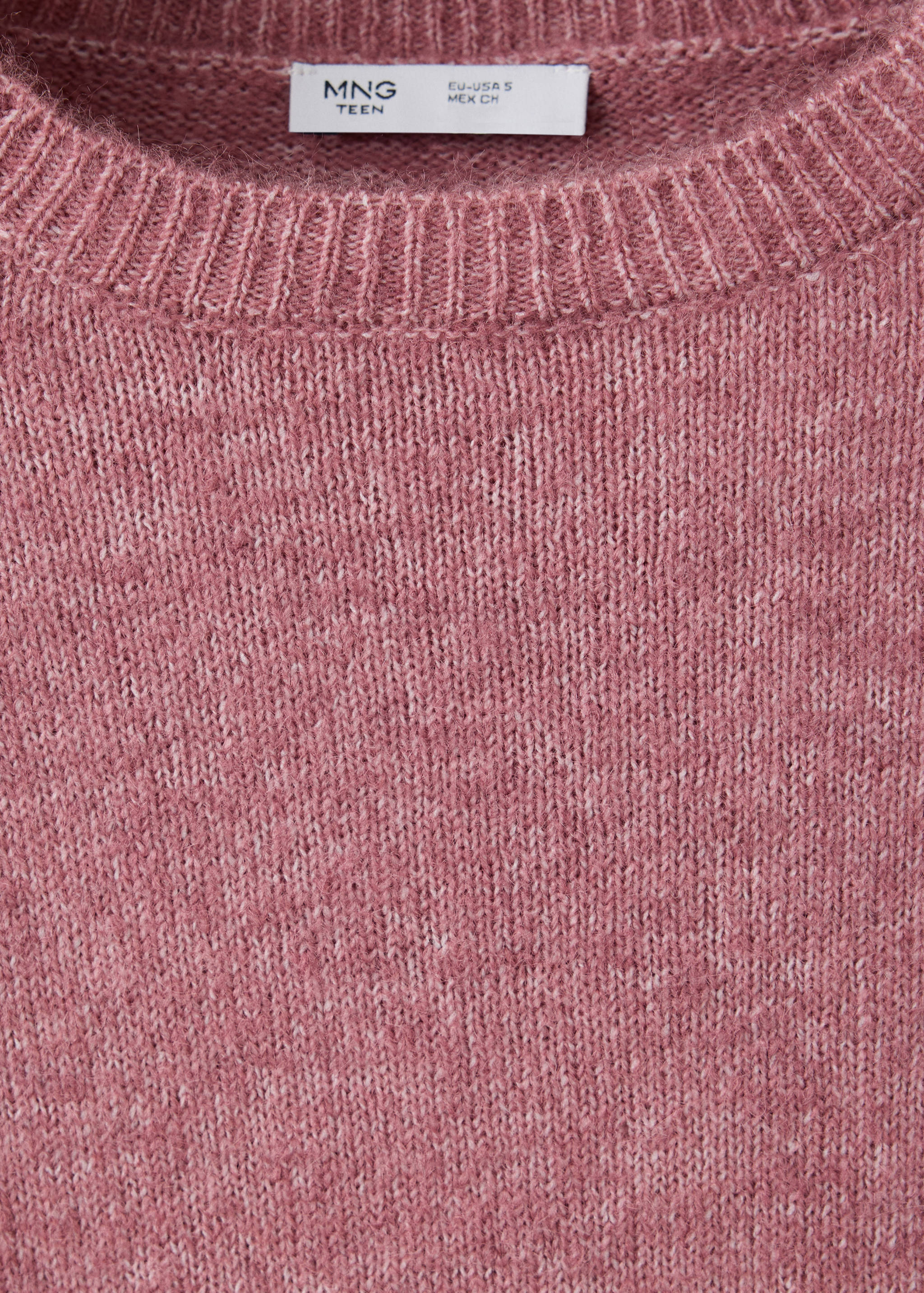 Close-up of a pink knitted jumper featuring a ribbed crew neck and brand label.