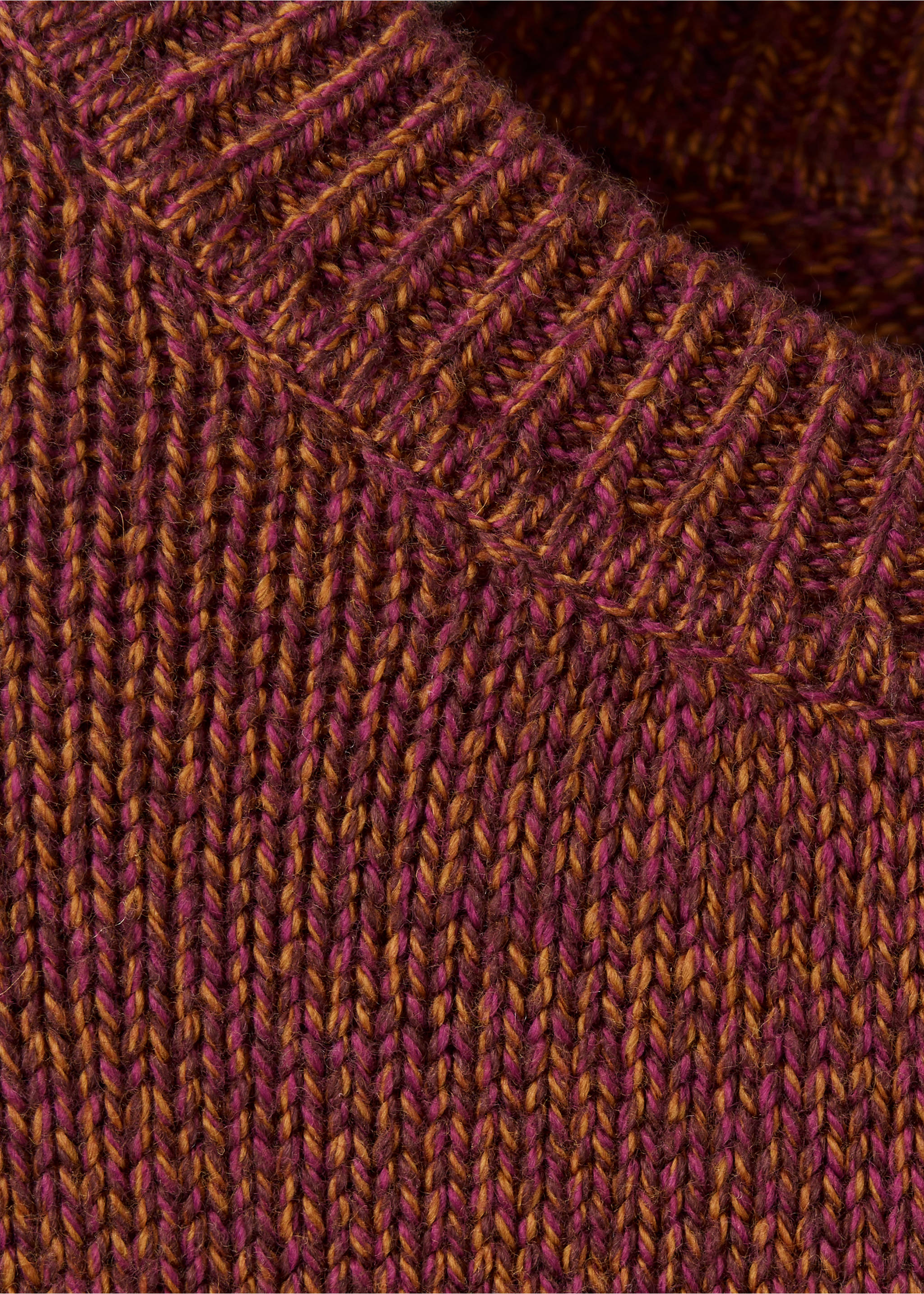 Close-up of a magenta and ochre marled knit jersey showing its ribbed texture., Cherry. Ref: 37008291-00.