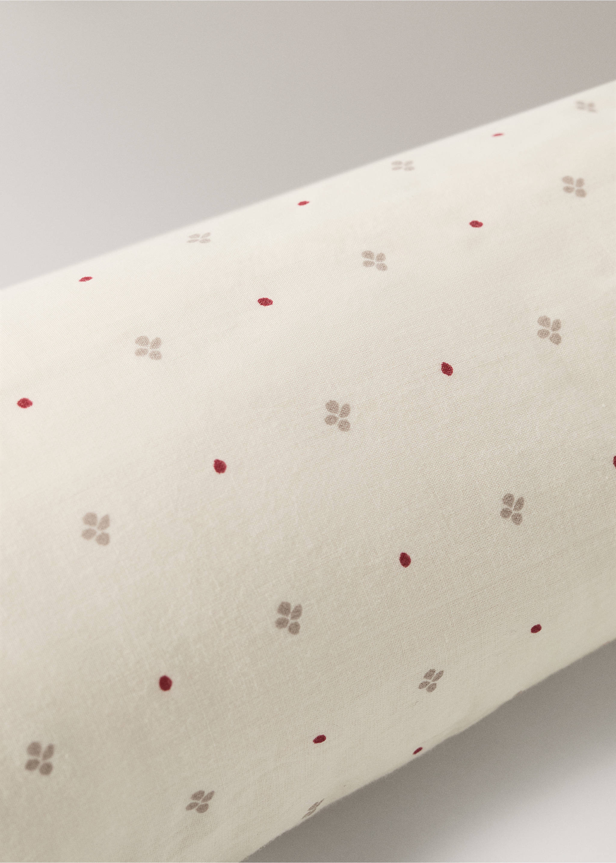 Close-up of a light-coloured cushion with small red dots and beige floral motifs., Red. Ref: 37008638-00.
