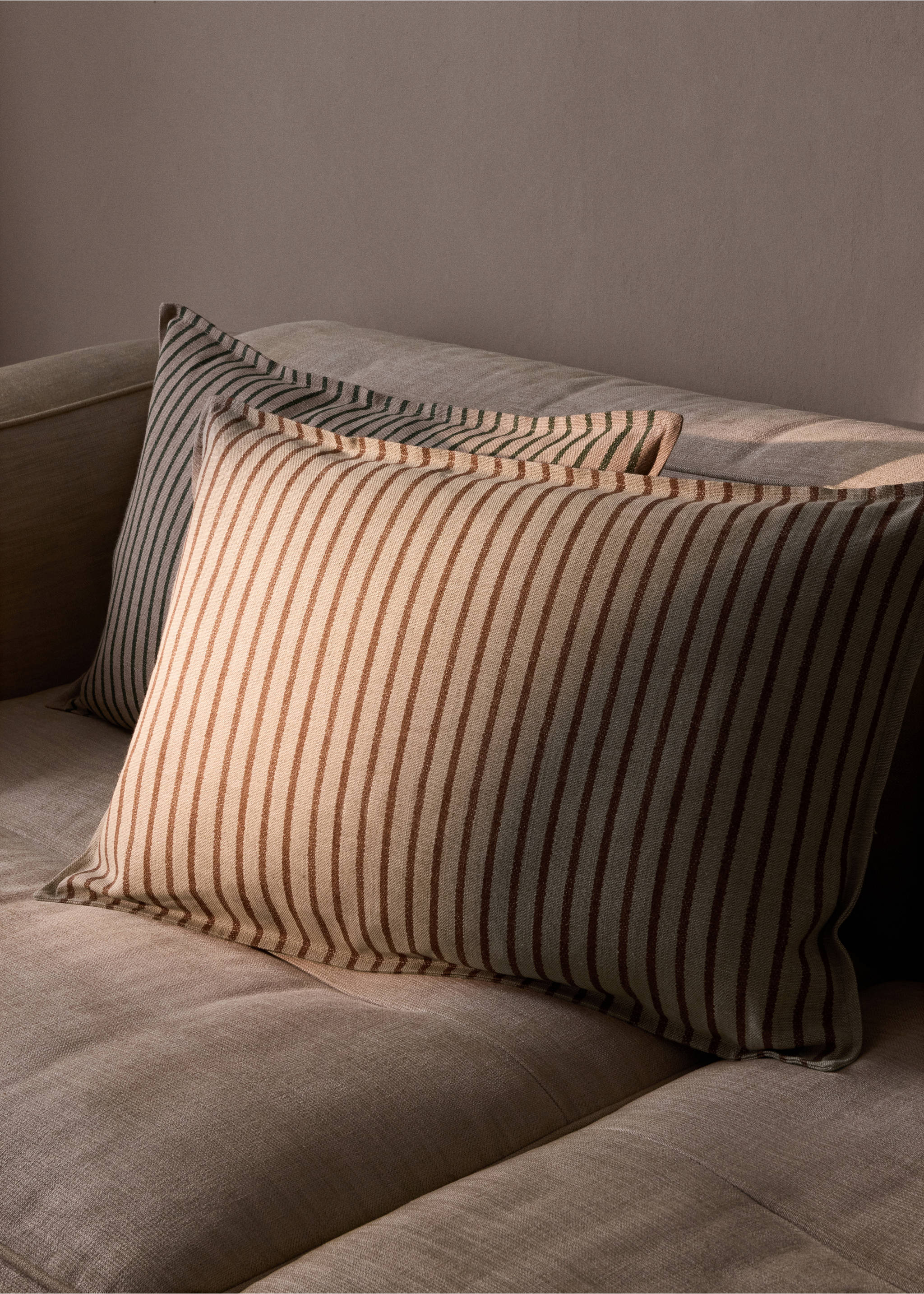 Brown striped bedding set styled with blue pillows and a blue throw blanket., Brown. Ref: 37008639-00.
