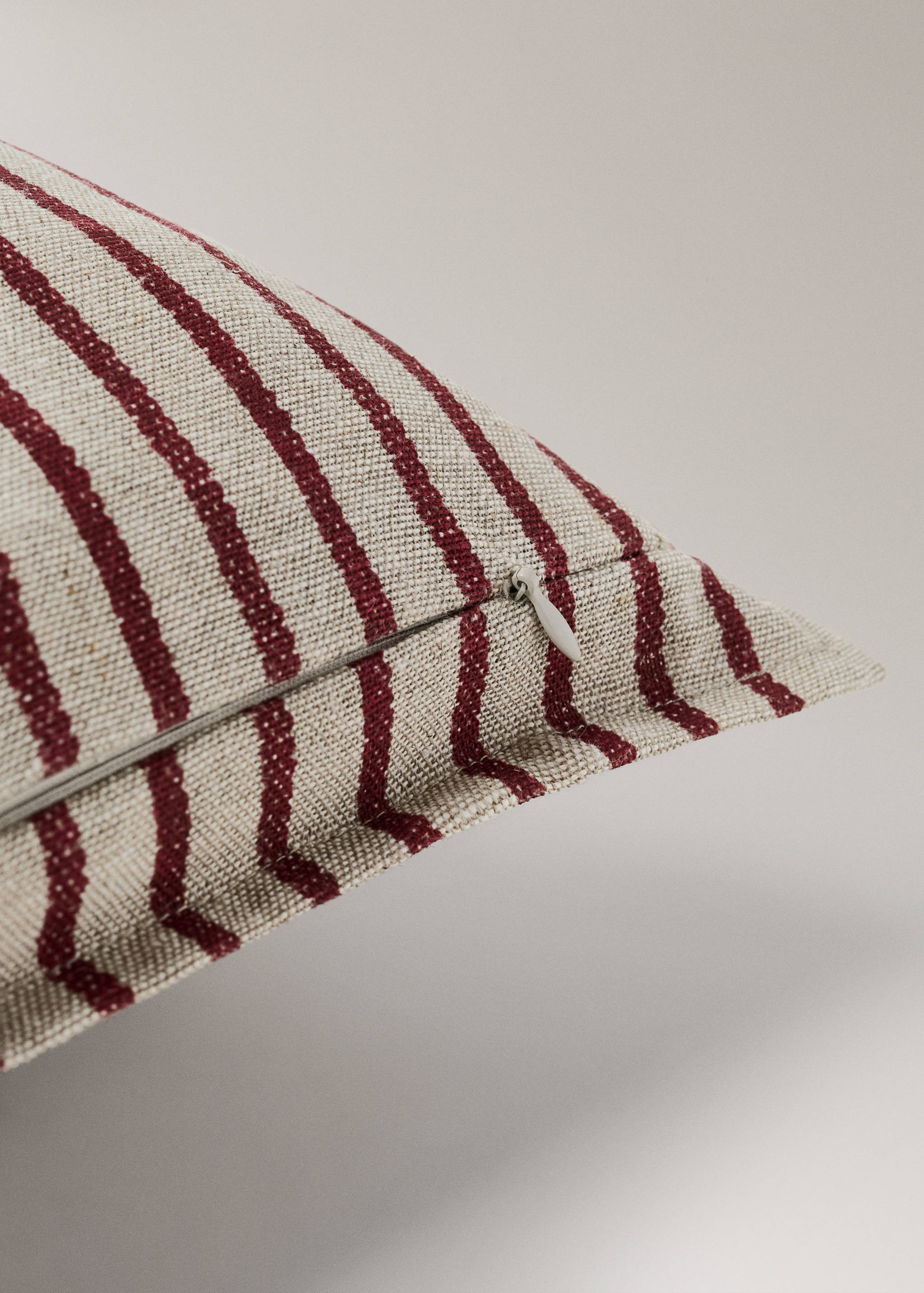 Close-up of a striped cushion cover with a concealed zipper.