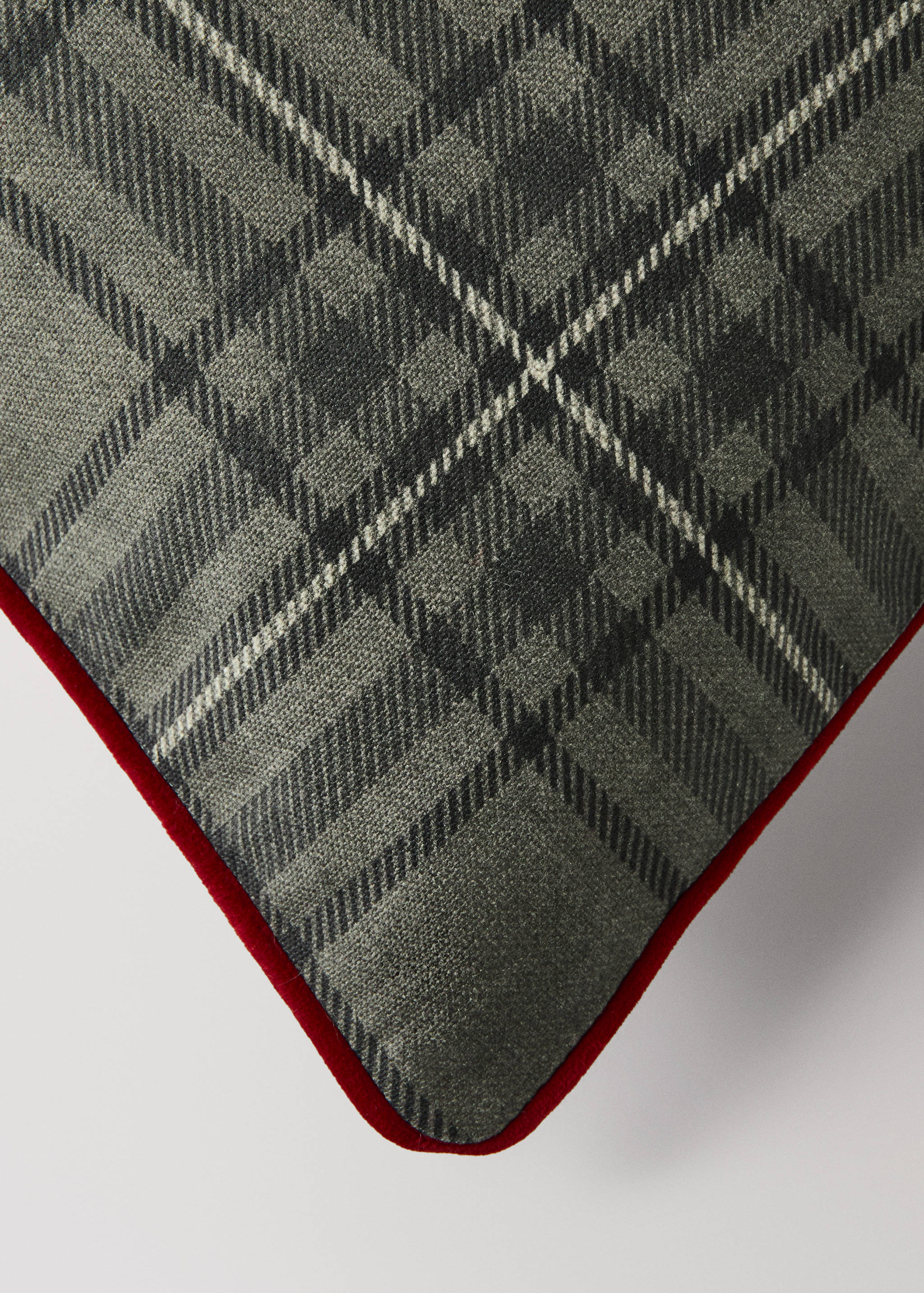 Grey tartan cushion cover with red velvet piping detail.
