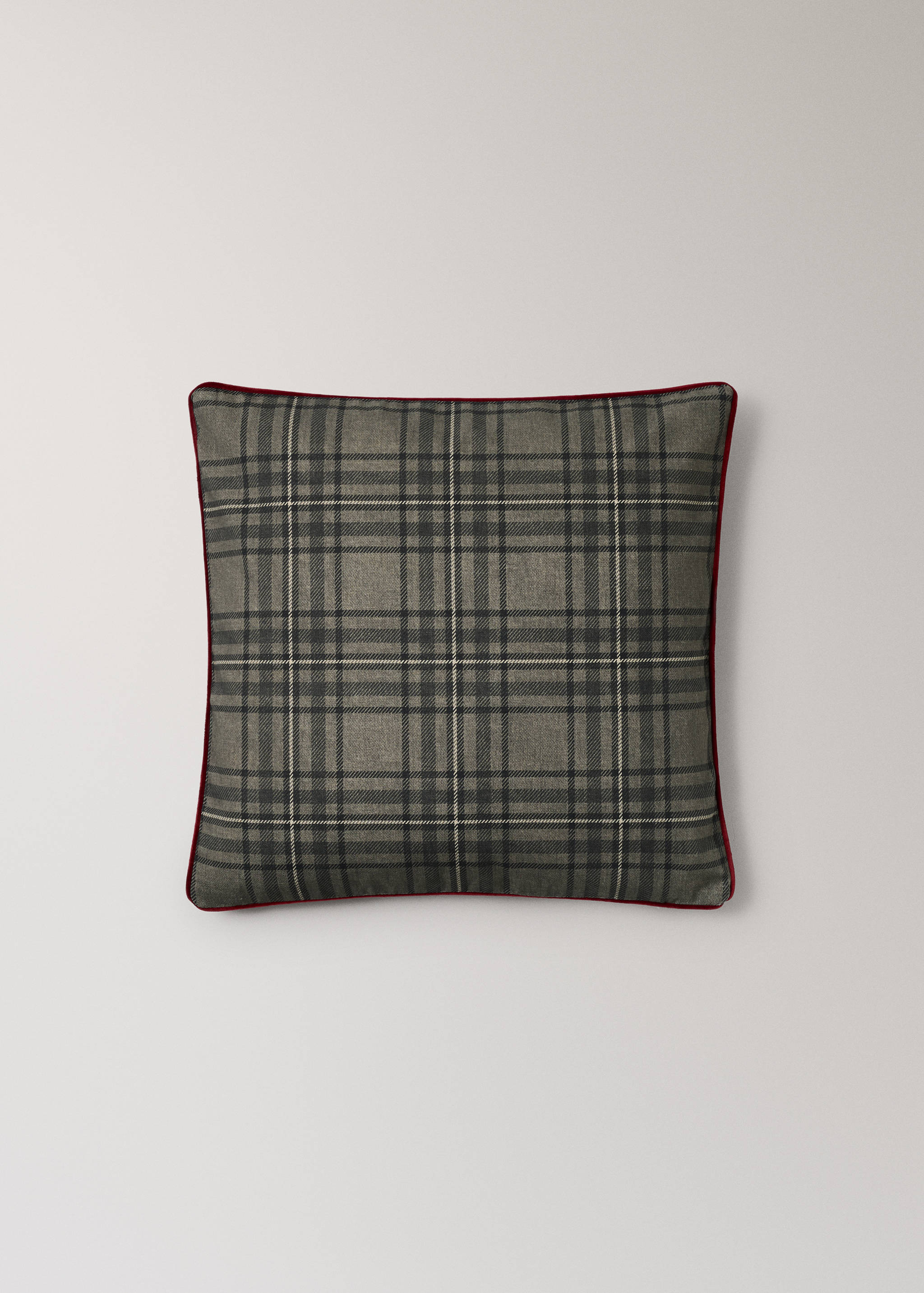 Grey tartan cushion cover with red piping trim.