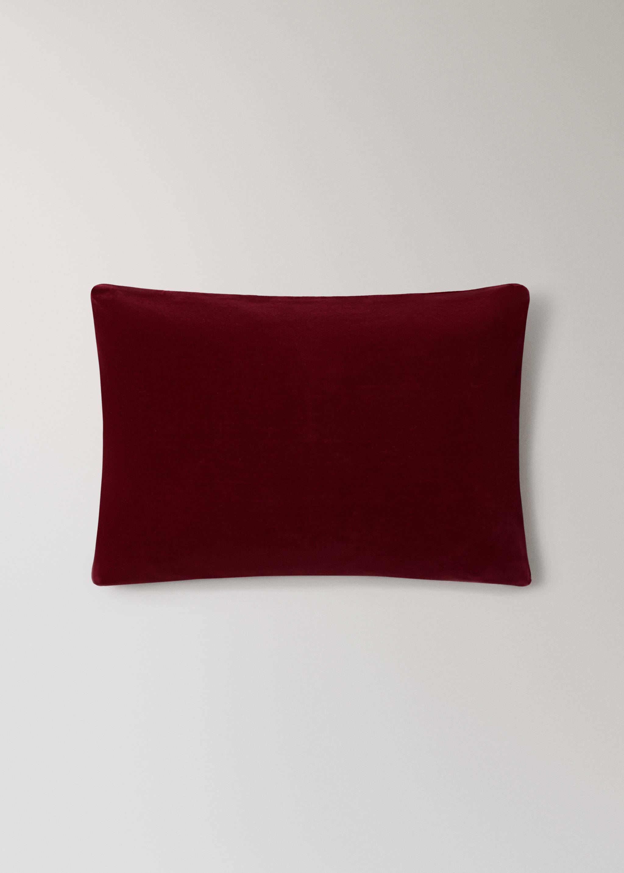 Deep burgundy velvet cushion cover in a rectangular shape.