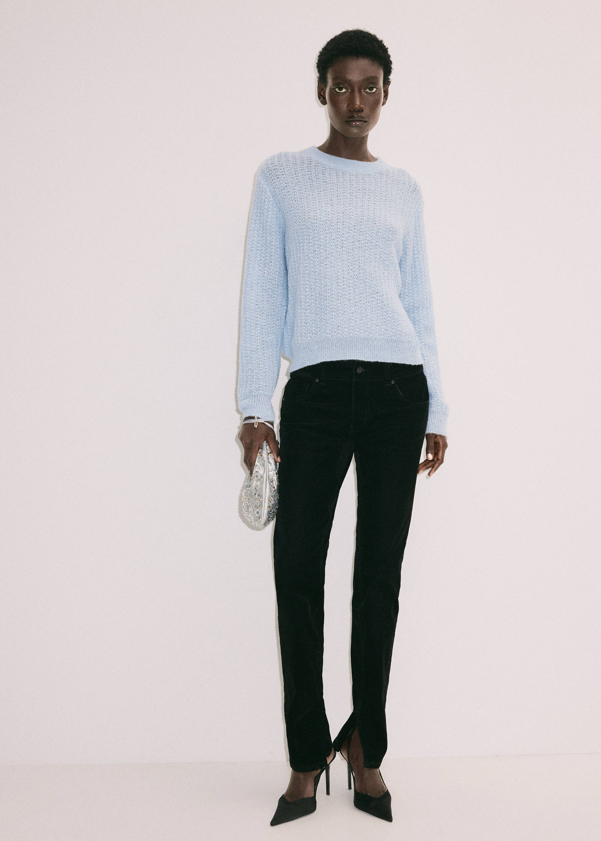 Light blue textured knit jersey with a round neck and long sleeves.
