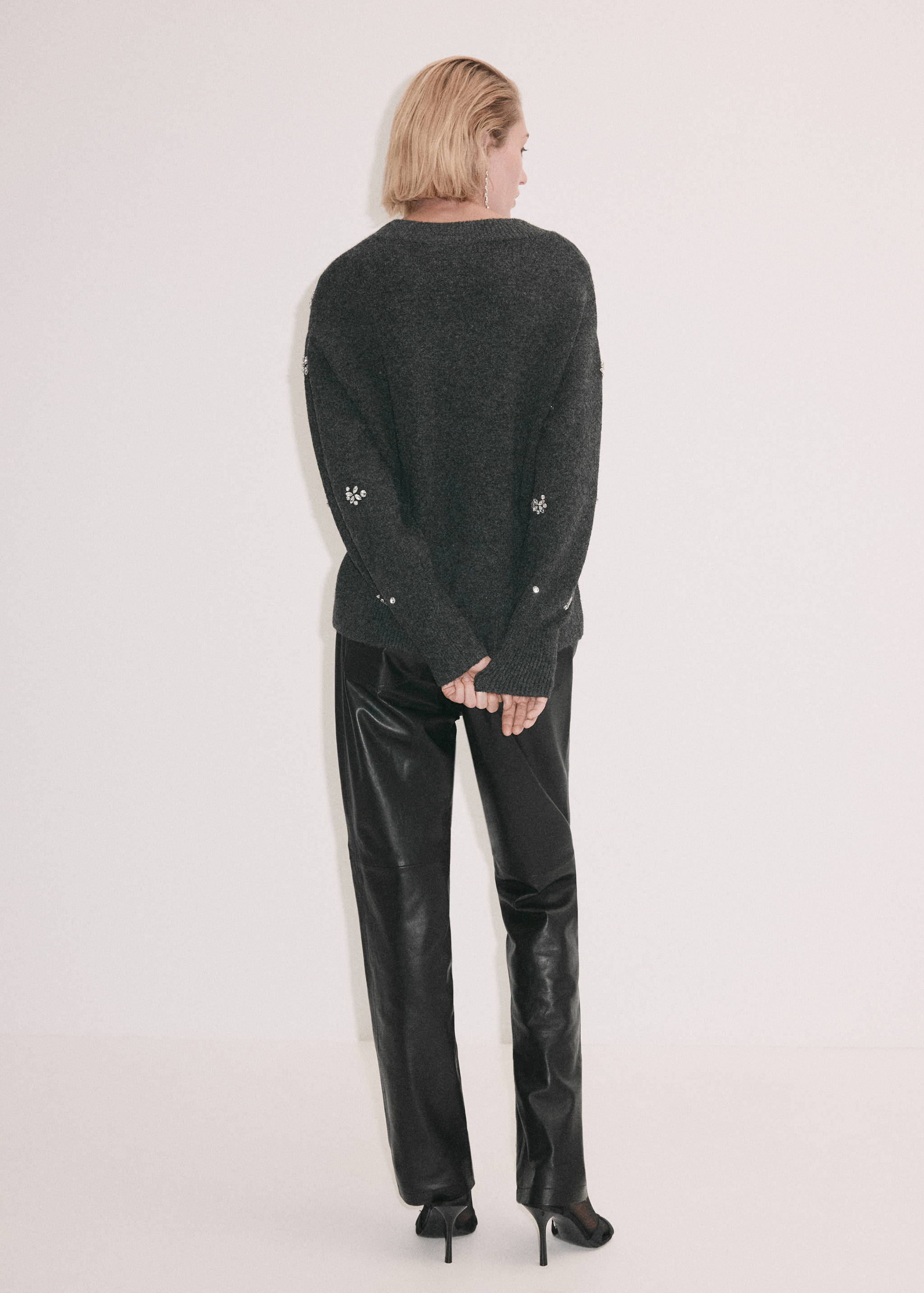 Dark grey knitted jersey with sparkly embellishments, shown from the back.