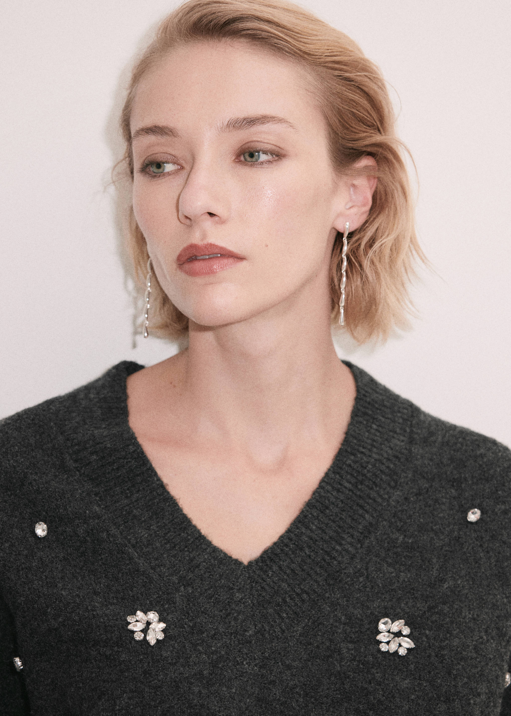 Dark grey V-neck jersey with crystal rhinestone embellishments.