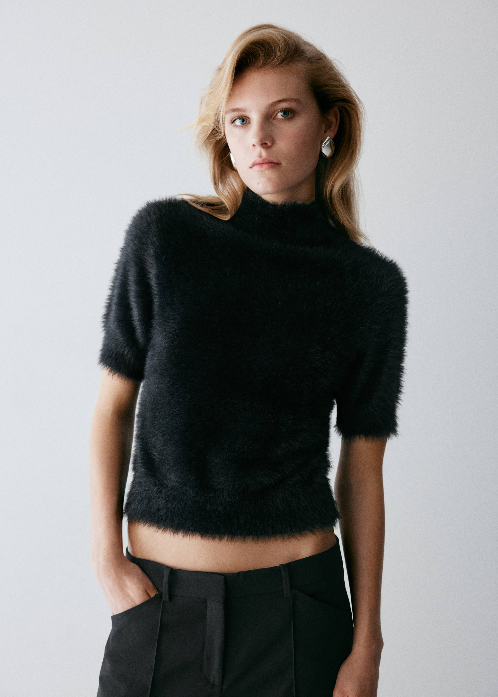 Black faux-fur short-sleeved jumper with a high neck.