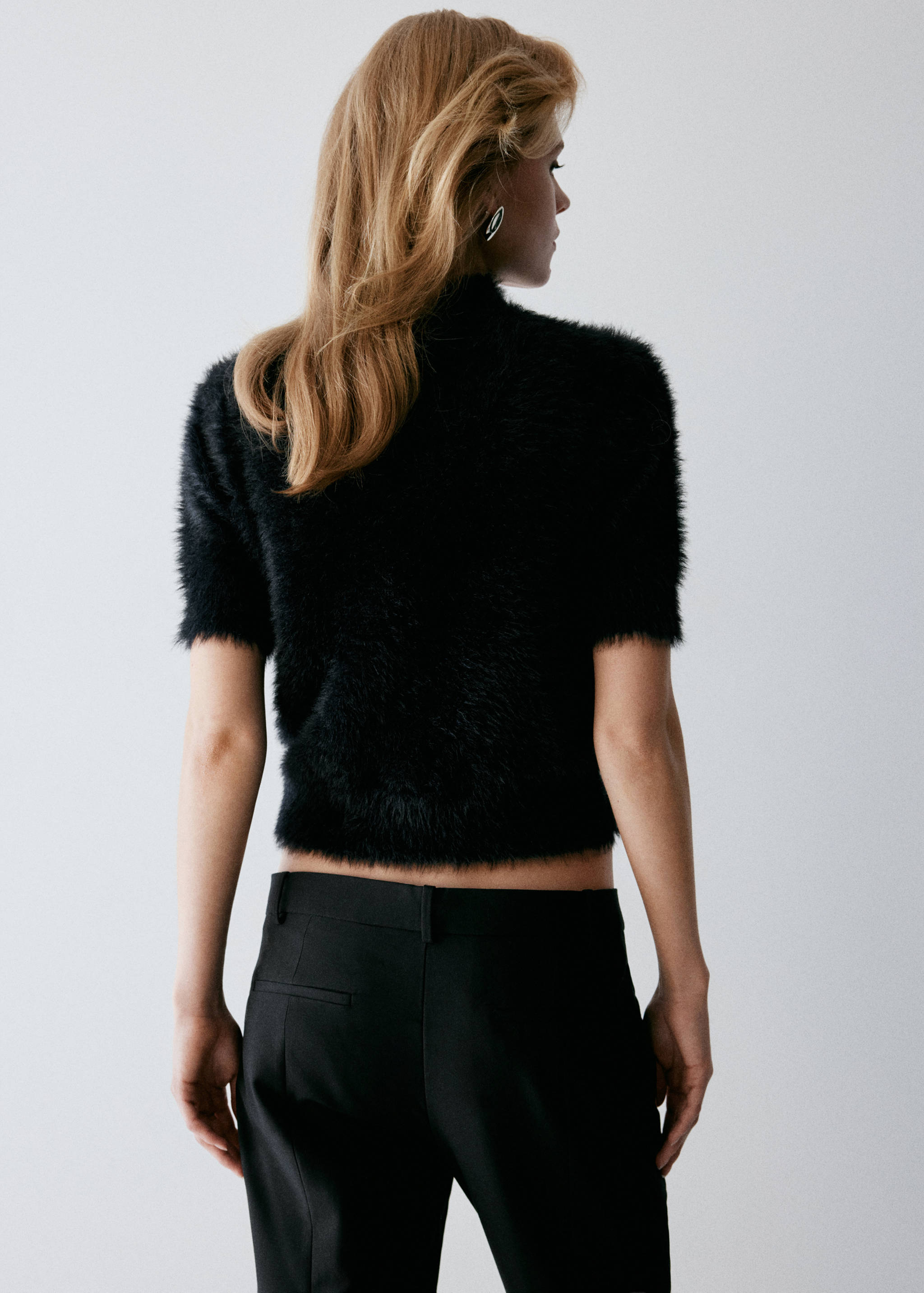 Black short-sleeved textured faux-fur jersey, back view.