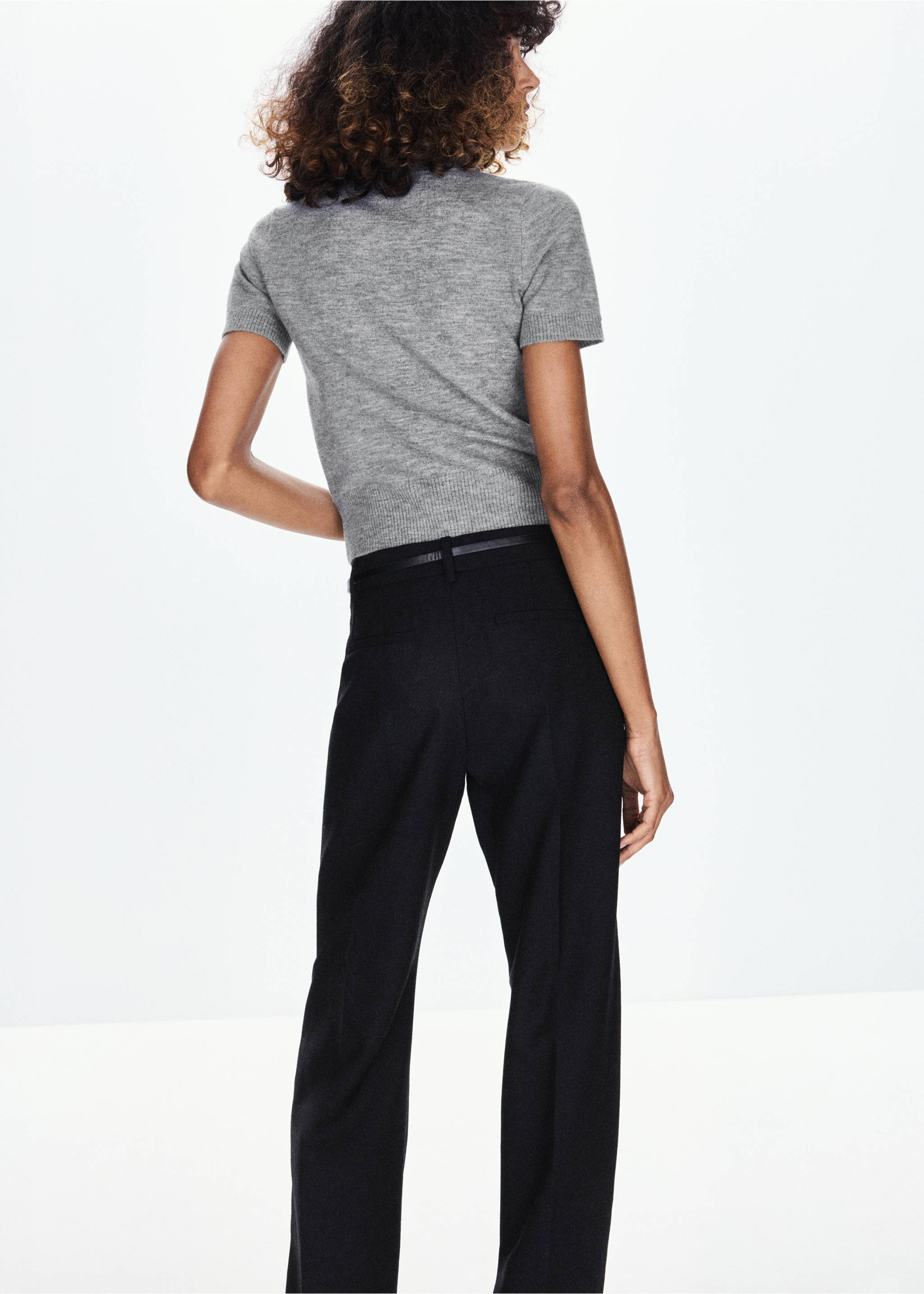 Grey short-sleeved knitted jersey shown from the back, paired with black trousers., Light Heather Grey. Ref: 37009133-00.