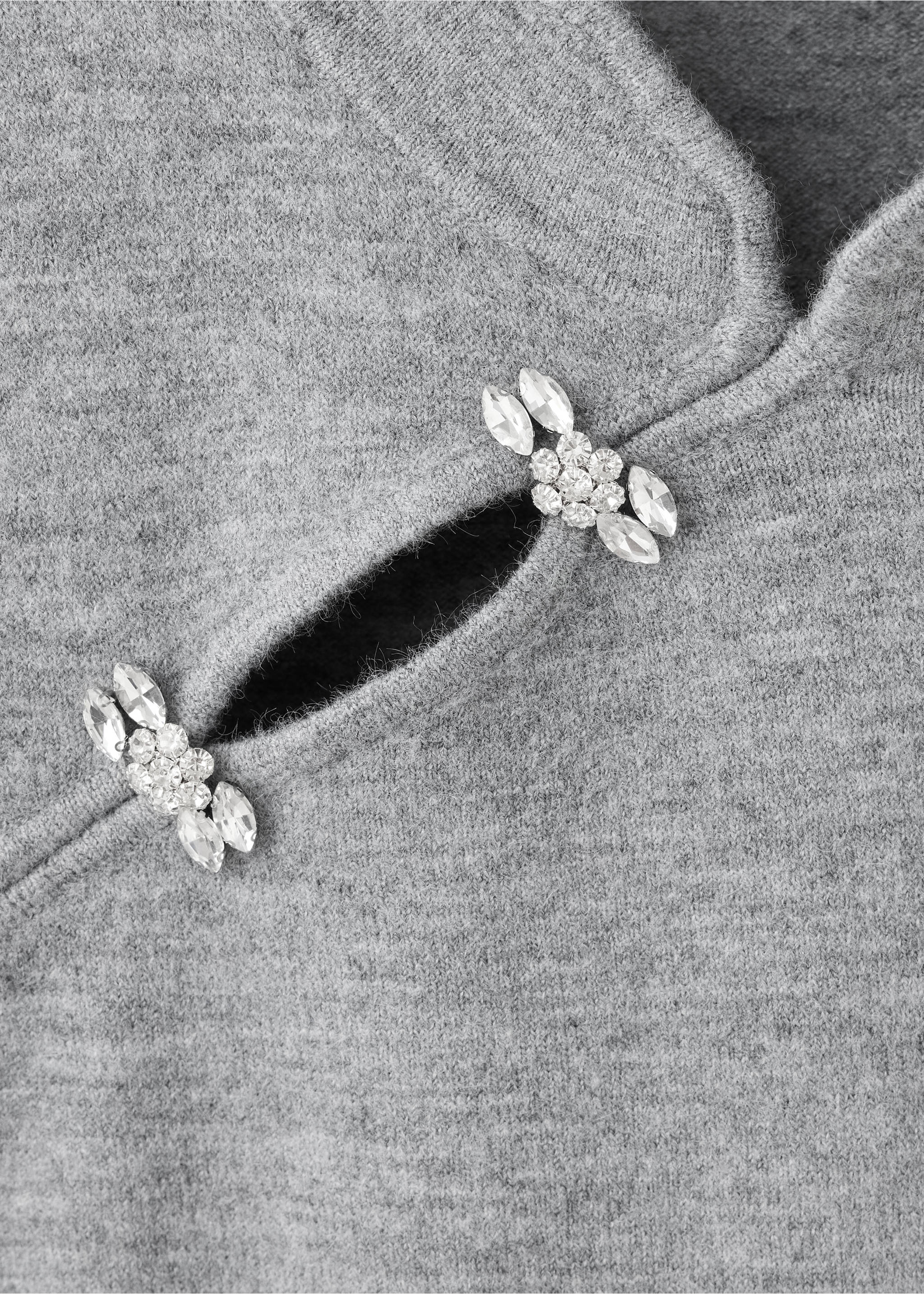 Close-up of a grey knit jersey with jewelled crystal clasps., Light Heather Grey. Ref: 37009133-00.