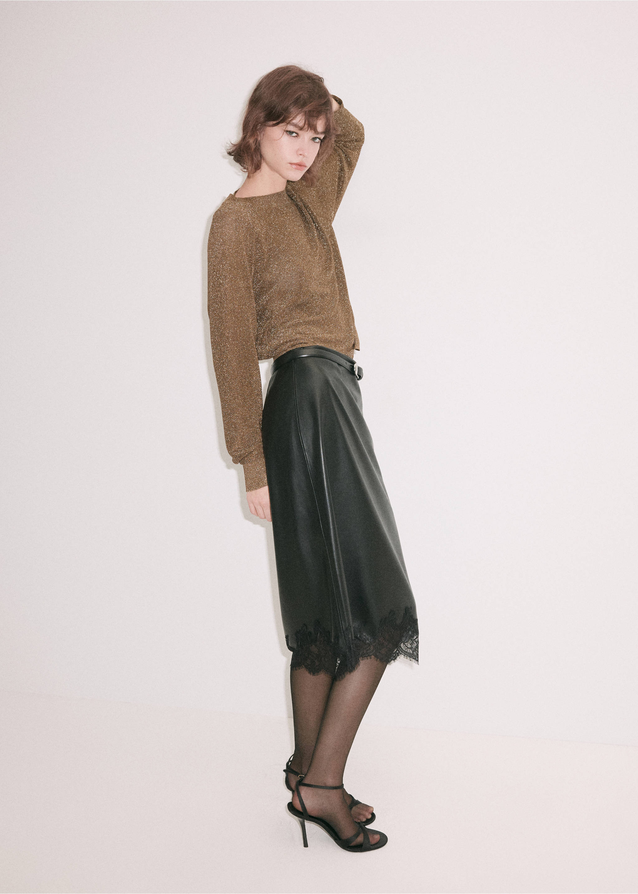 Metallic bronze jersey with long sleeves, worn with a black midi skirt., Gold. Ref: 37009140-00.