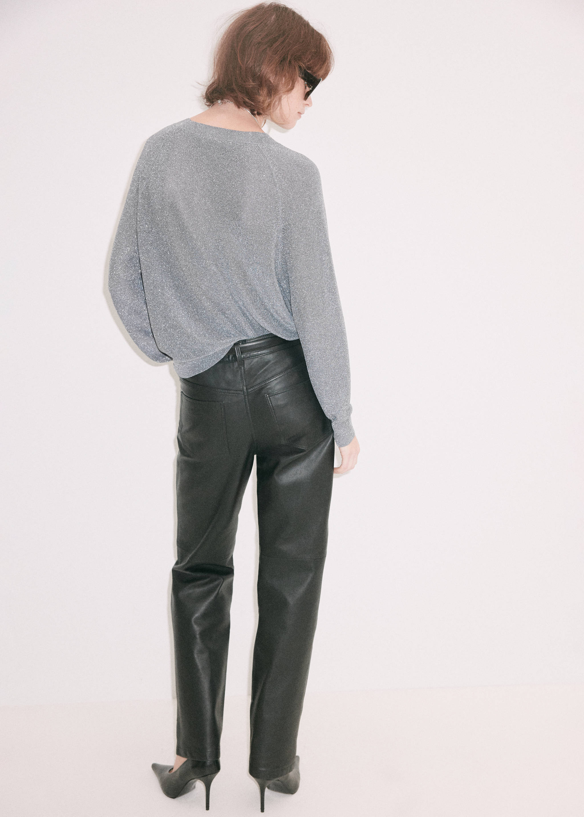 Grey glittery knit sweater with long raglan sleeves, seen from the back.