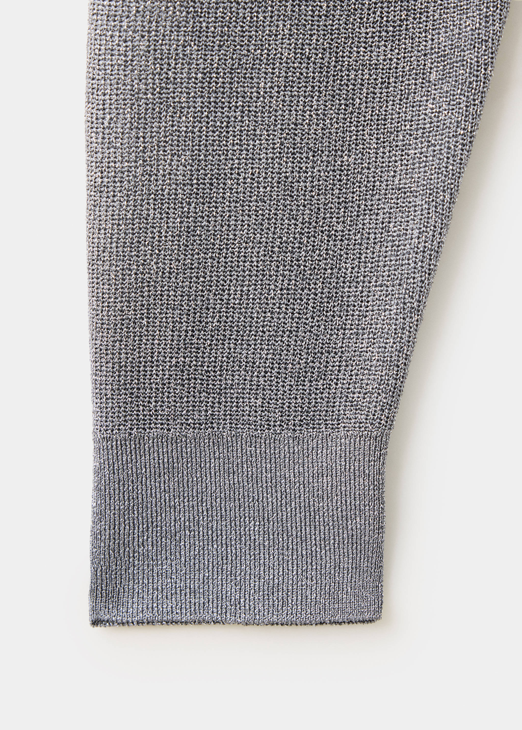 Close-up of a grey jersey showing the fine knit fabric and ribbed cuff.