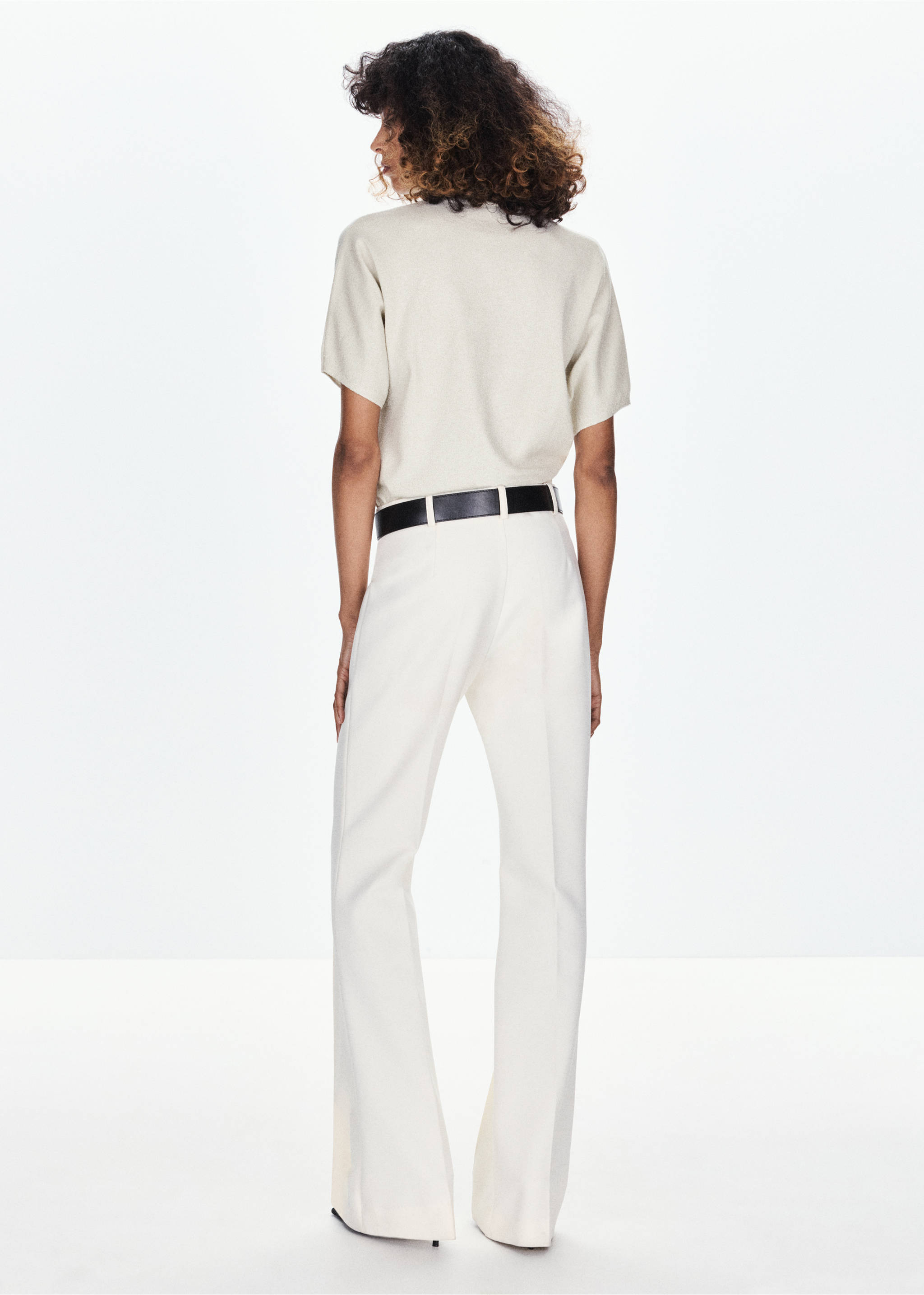 Back view of a beige short-sleeved jersey worn with cream trousers., Gold. Ref: 37009141-00.