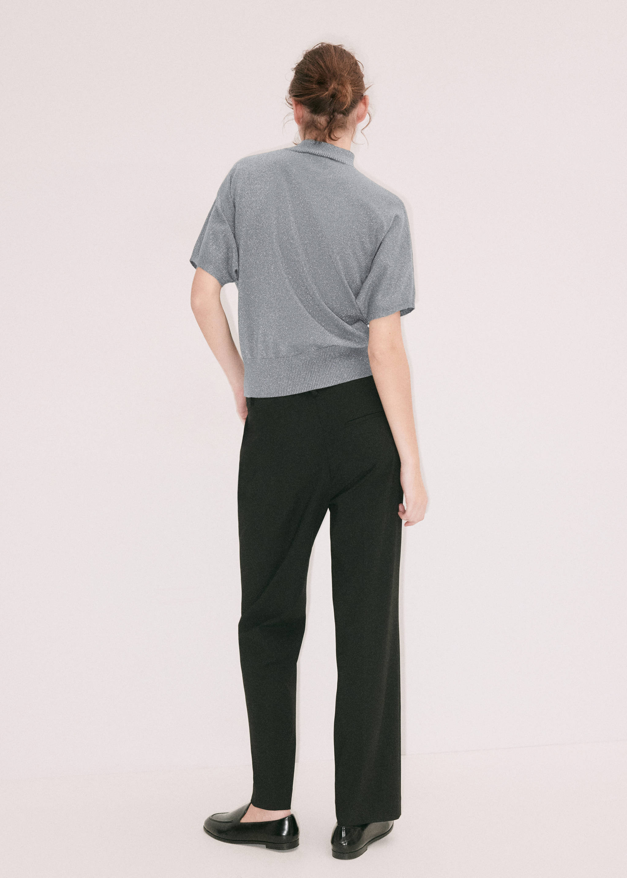 Grey metallic knit jumper with short sleeves and high neck, back view.