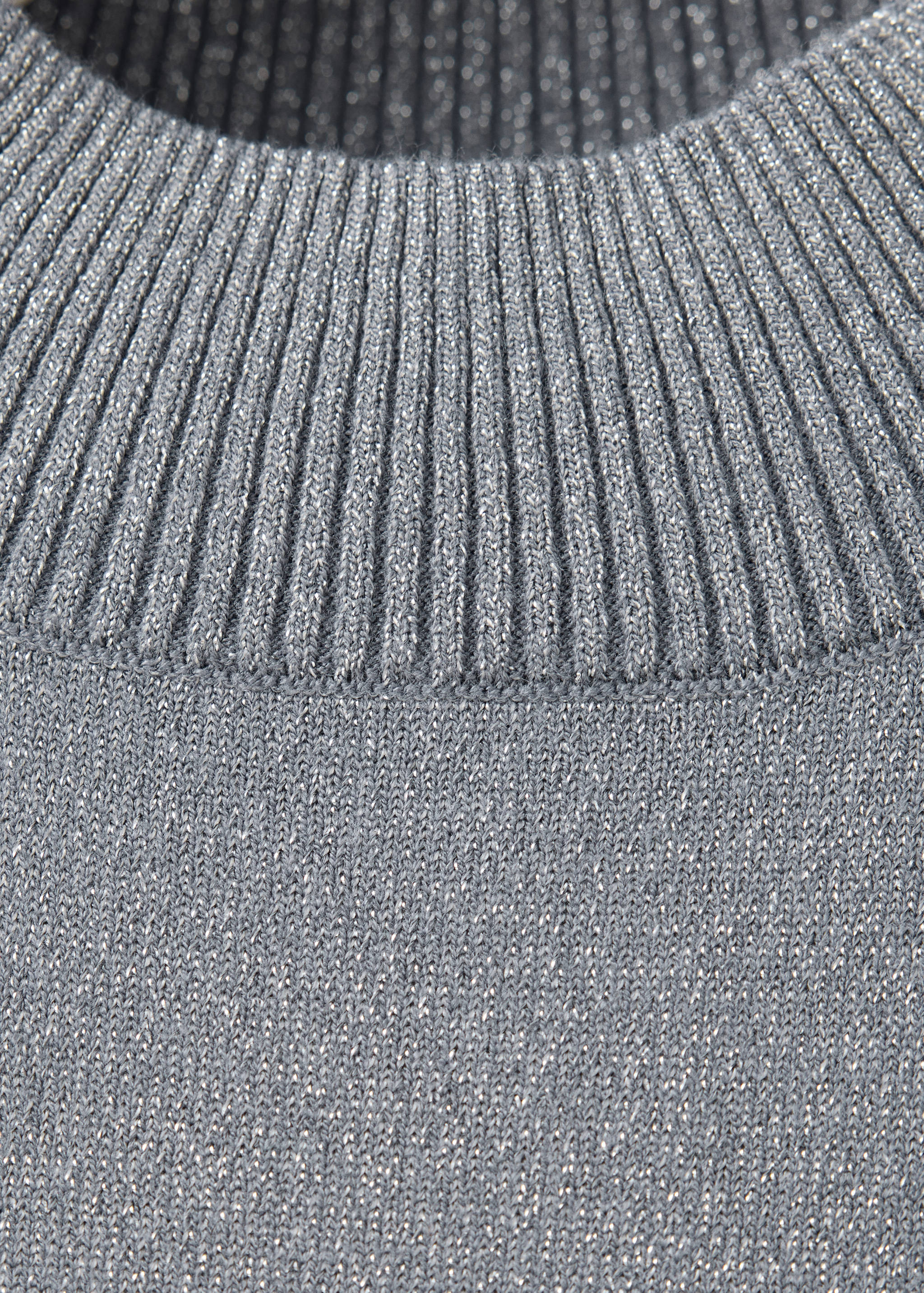 Close-up of a grey metallic jersey neckline and ribbed knit.