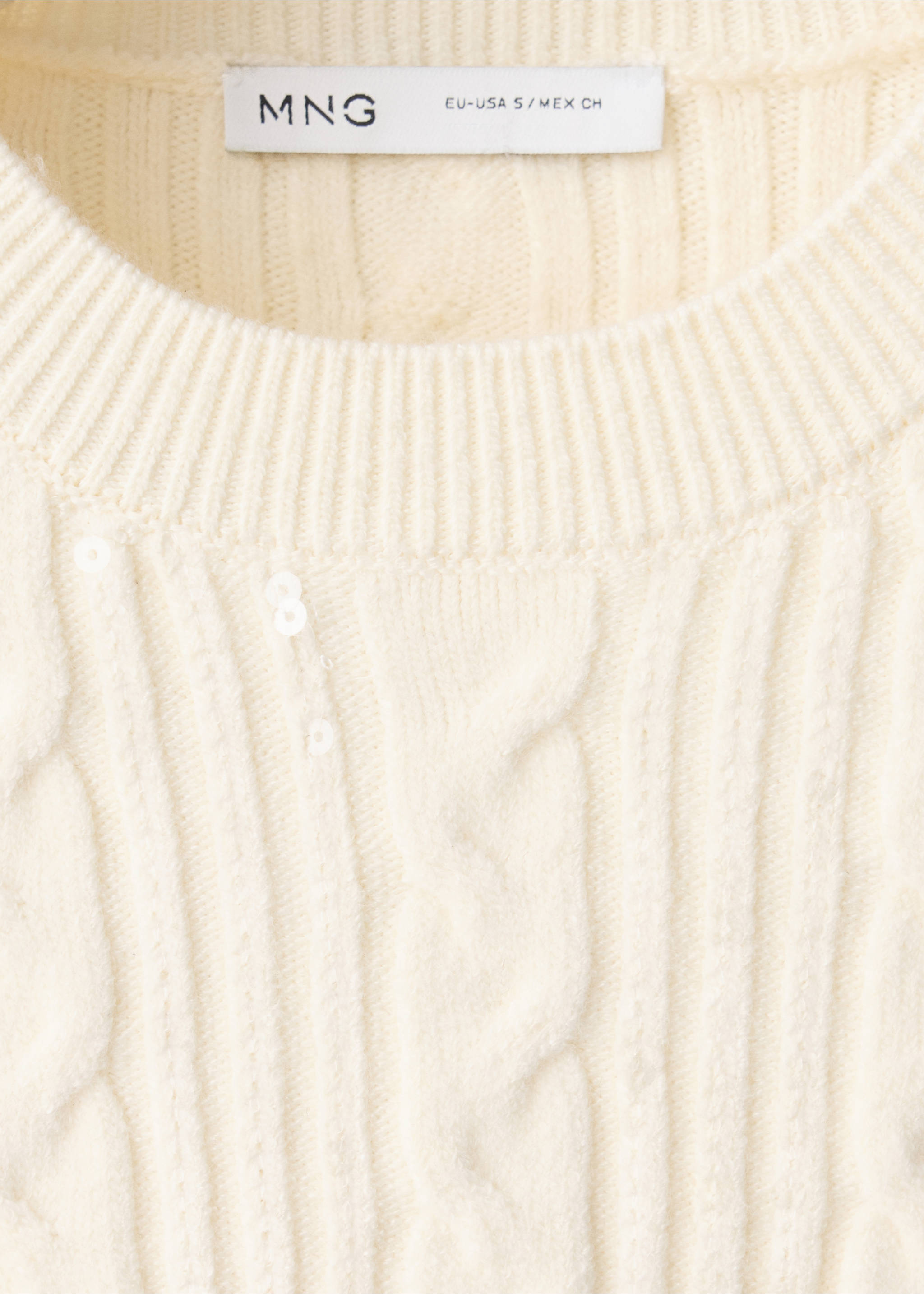 Close-up of a cream cable-knit jersey with subtle sequins and a ribbed neckline., Vanilla. Ref: 37009144-00.