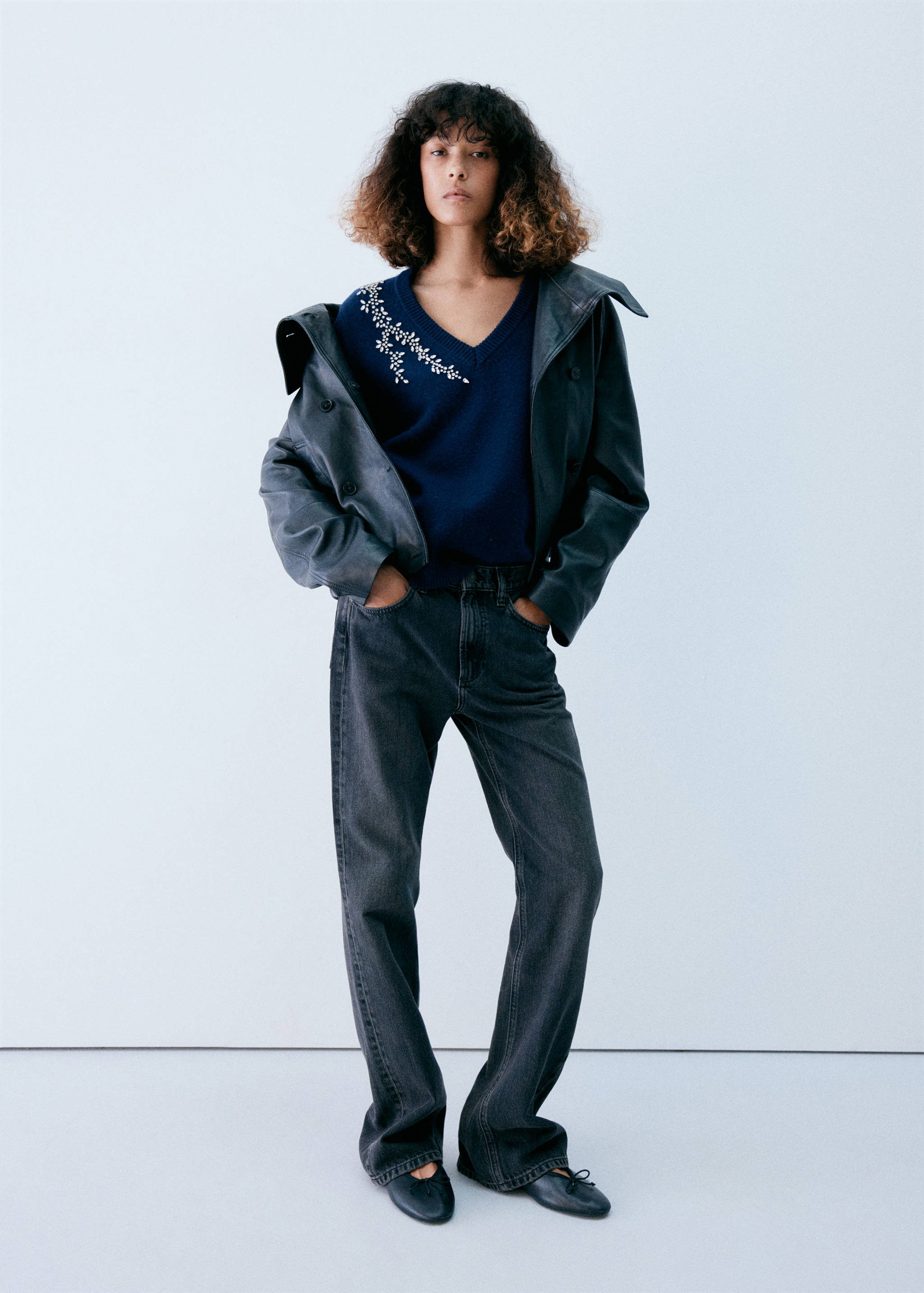 Dark blue V-neck jersey with beaded floral embellishment.