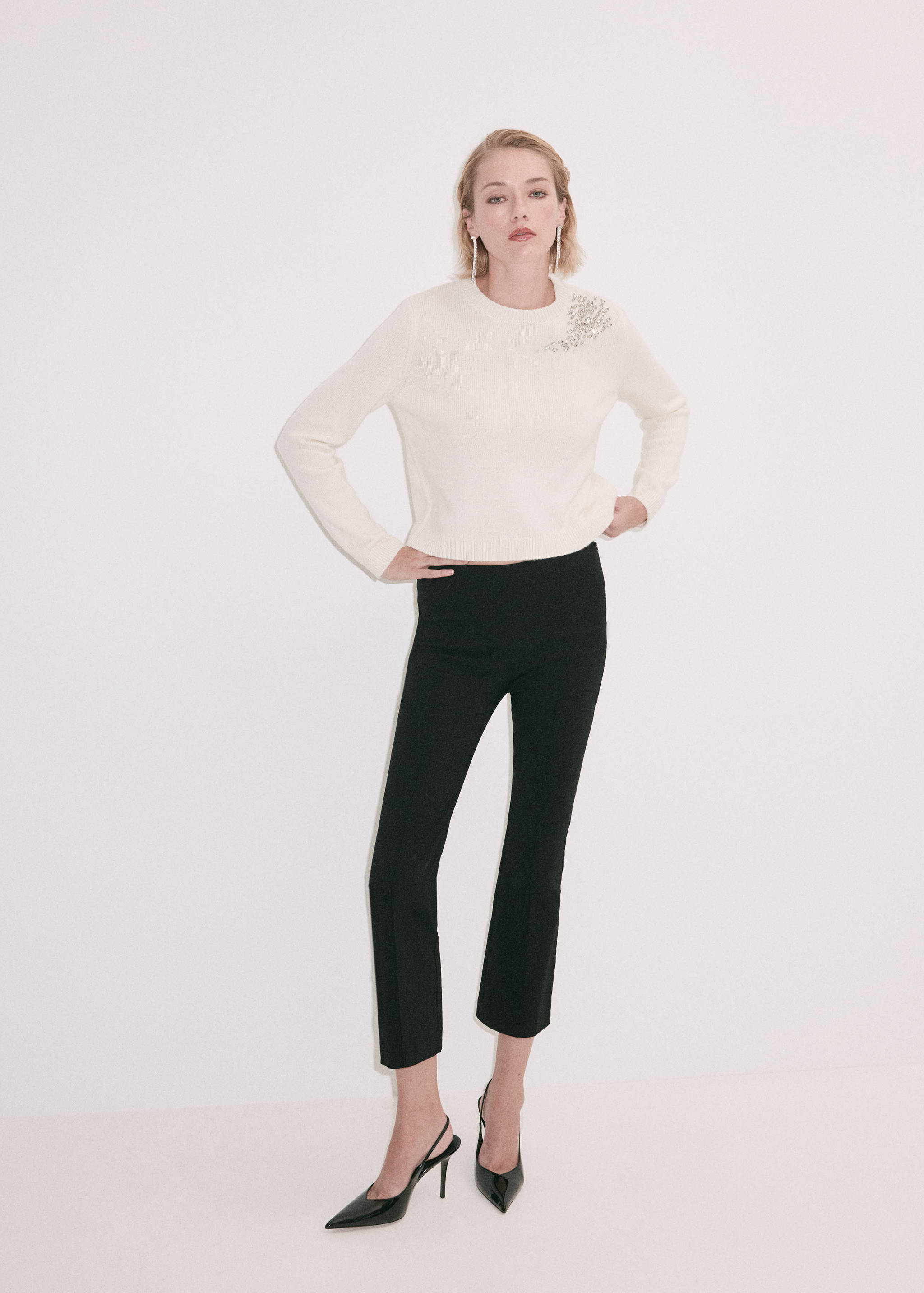 Off-white jersey with round neck and crystal shoulder embellishment.