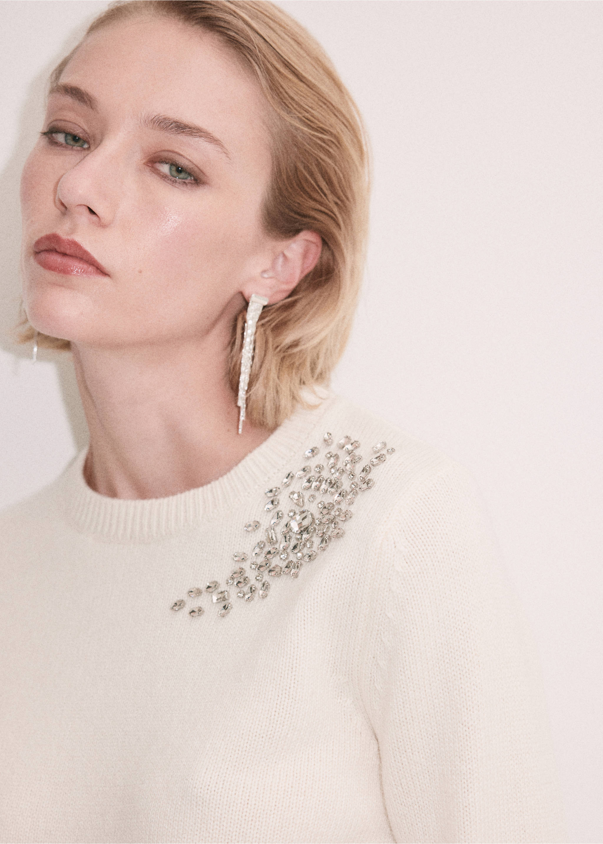 Close-up of an off-white knitted jumper with rhinestone shoulder embellishment., Ecru. Ref: 37009153-00.