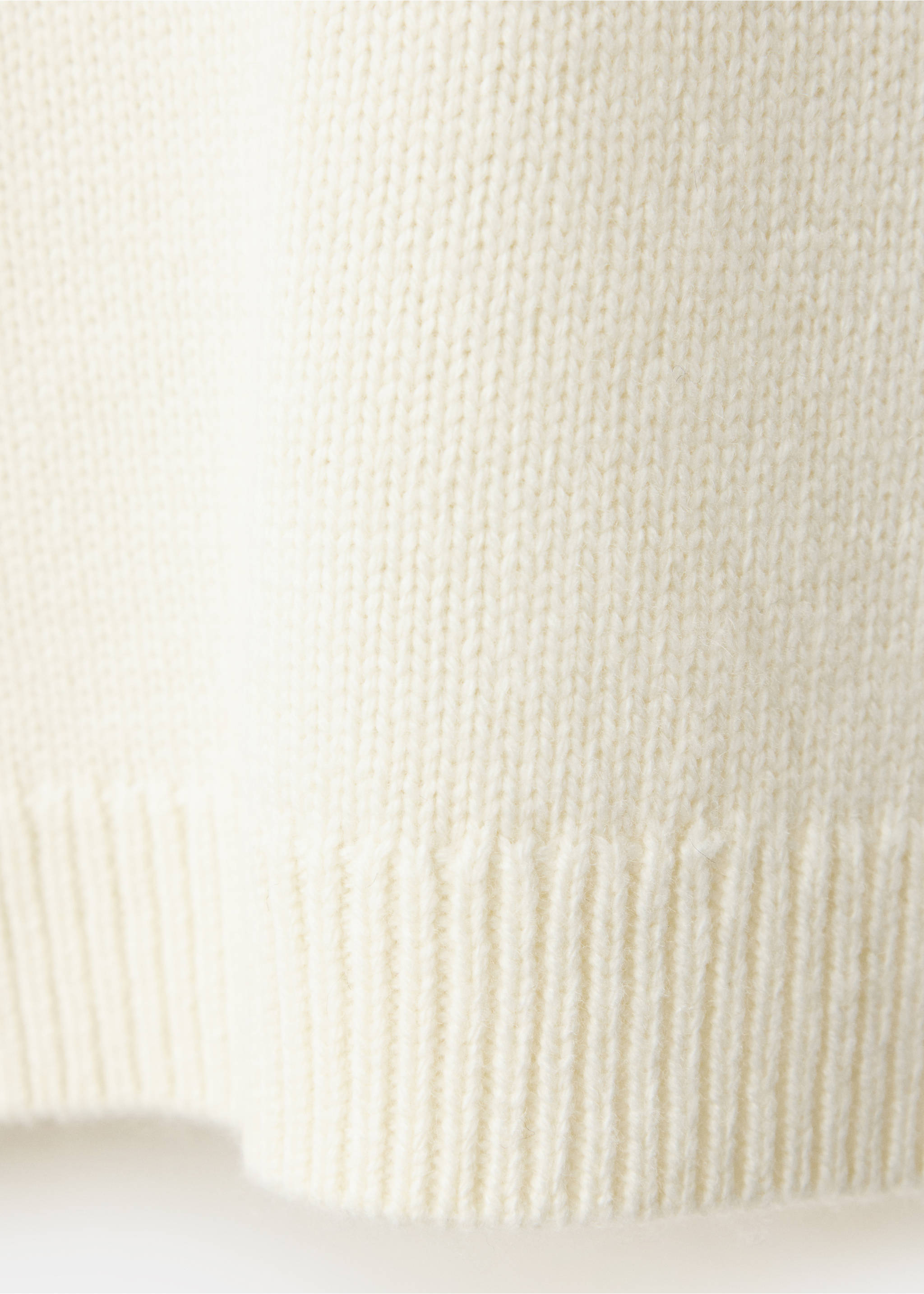 Close-up of the cream knit fabric and ribbed hem of a jersey., Ecru. Ref: 37009153-00.