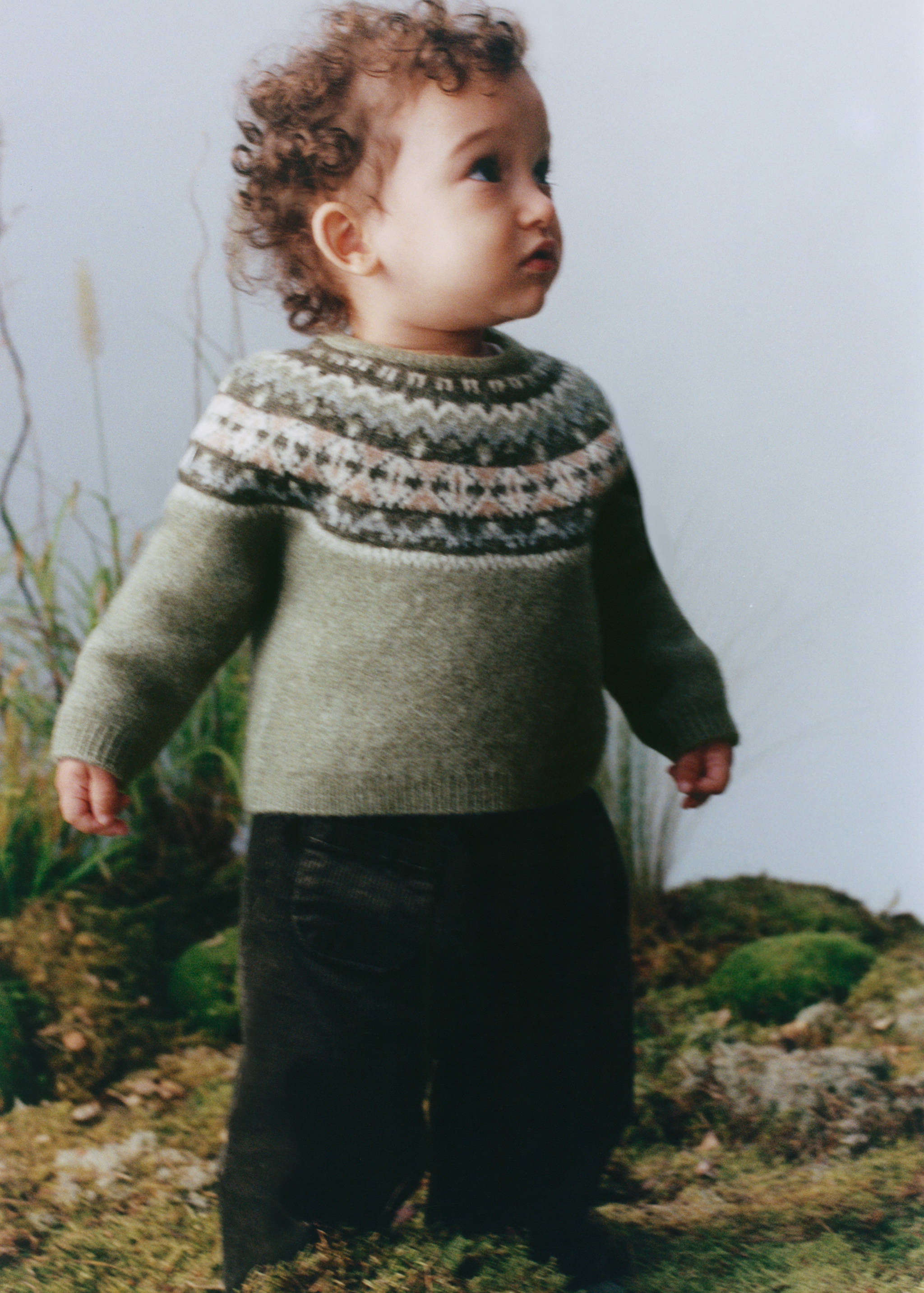 Green Fair Isle knit sweater with a patterned yoke and round neckline.