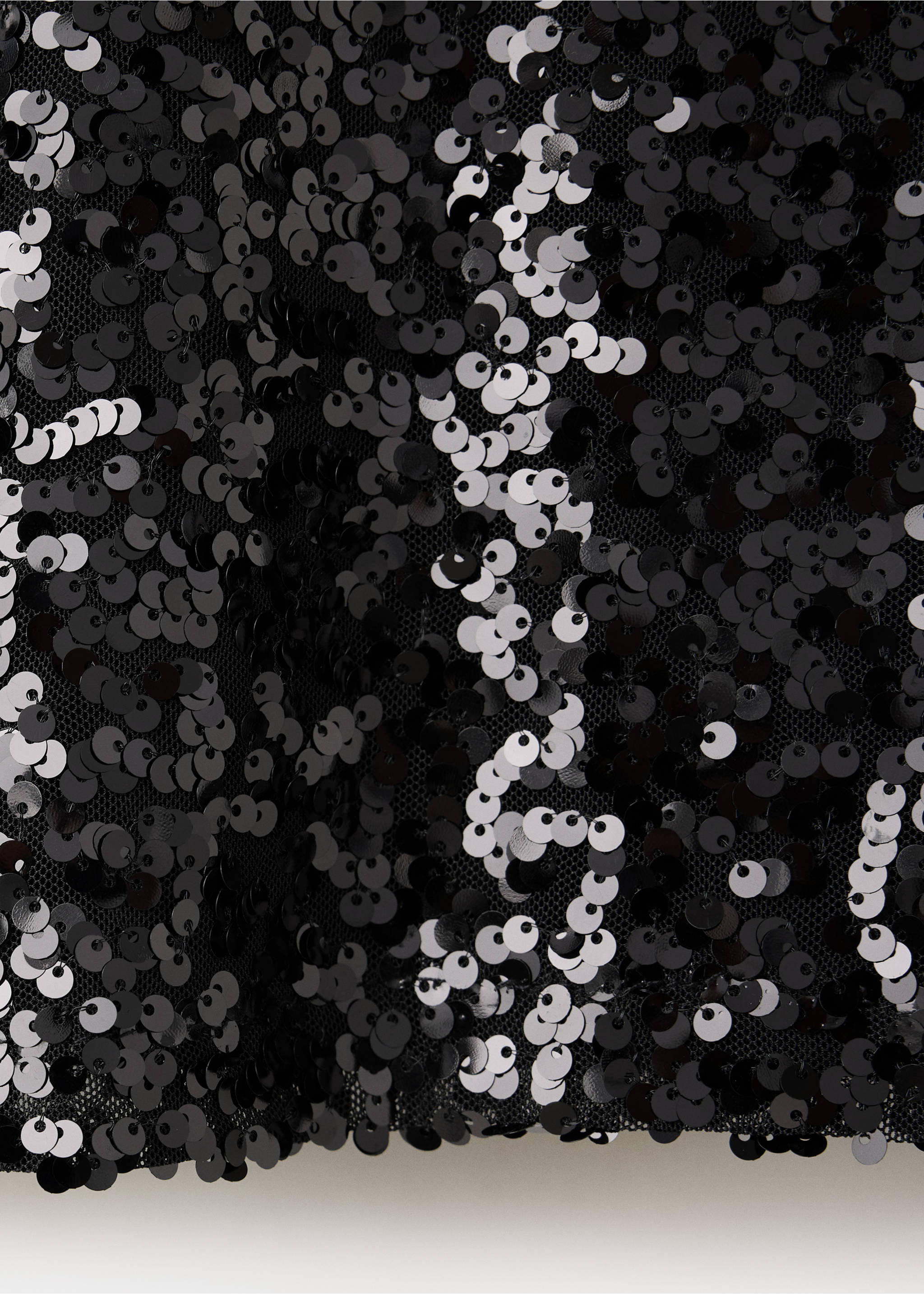 Close-up of a black sequin t-shirt fabric showing shimmering sequins on mesh., Black. Ref: 37009215-00.