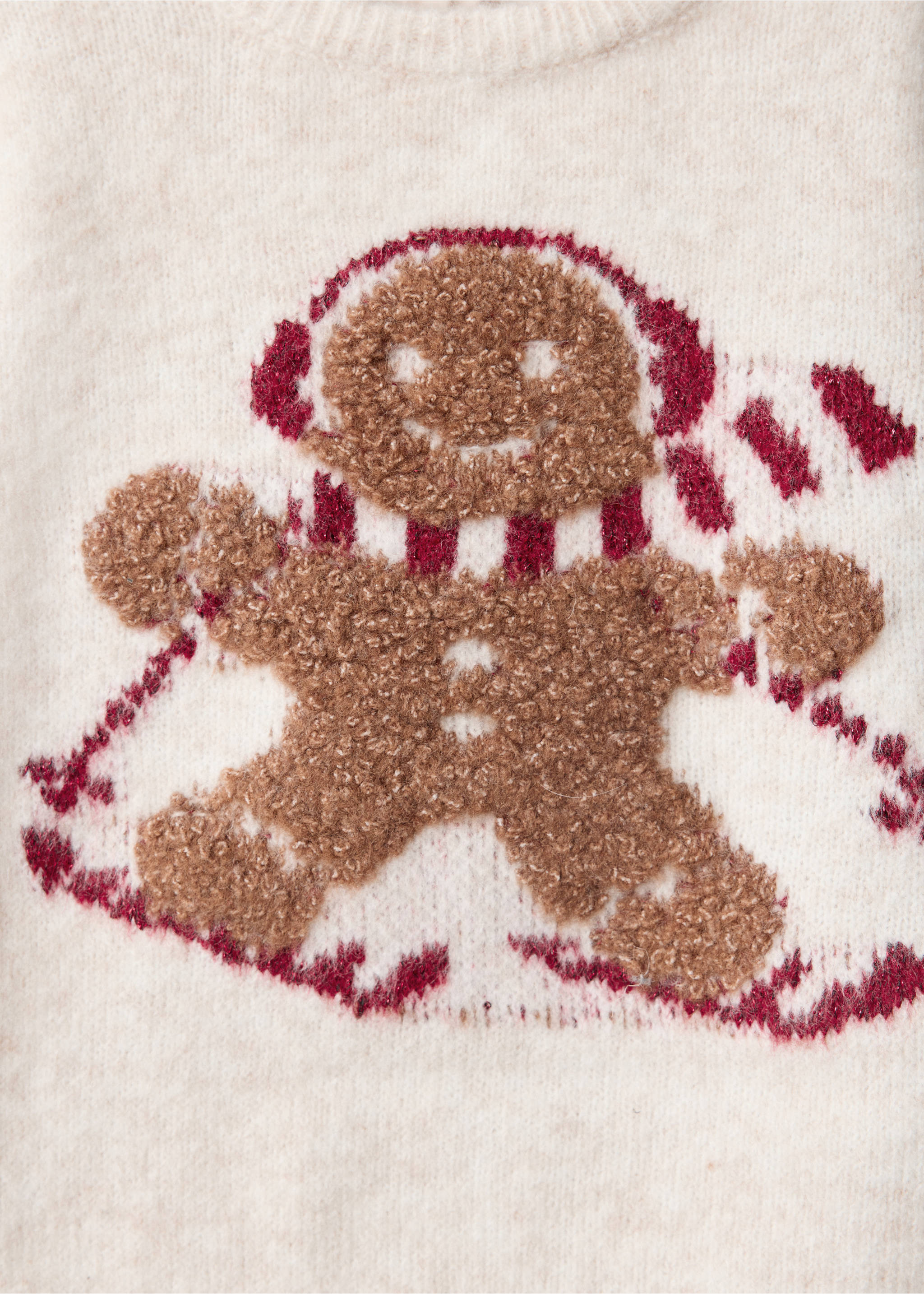 Close-up of a cream jumper with a textured brown gingerbread man graphic., Beige. Ref: 37009218-00.
