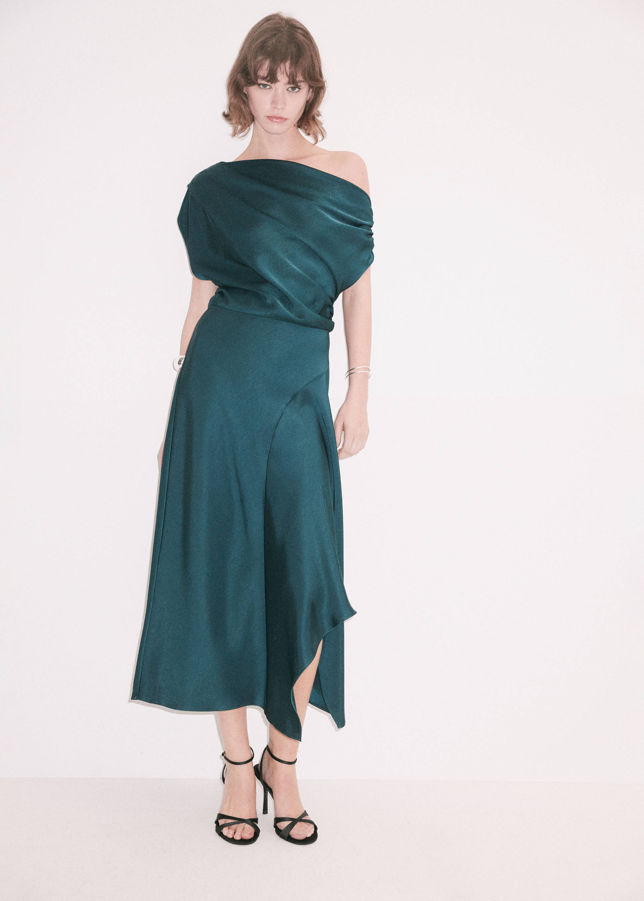 Dark teal one-shoulder midi dress with a draped bodice and handkerchief hem.