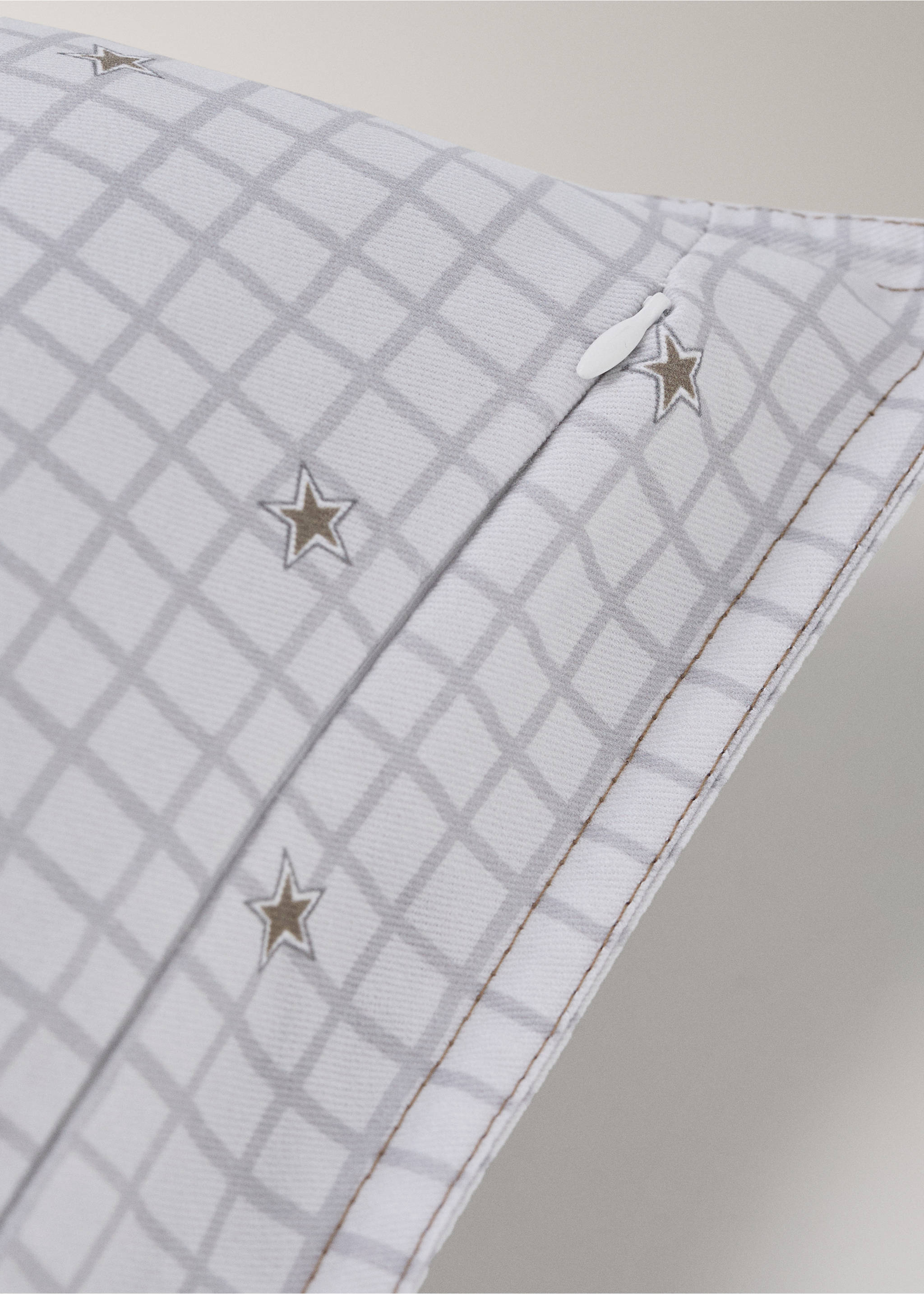 Close-up of a white cushion cover with a grey grid and star print., Grey. Ref: 37014462-00.