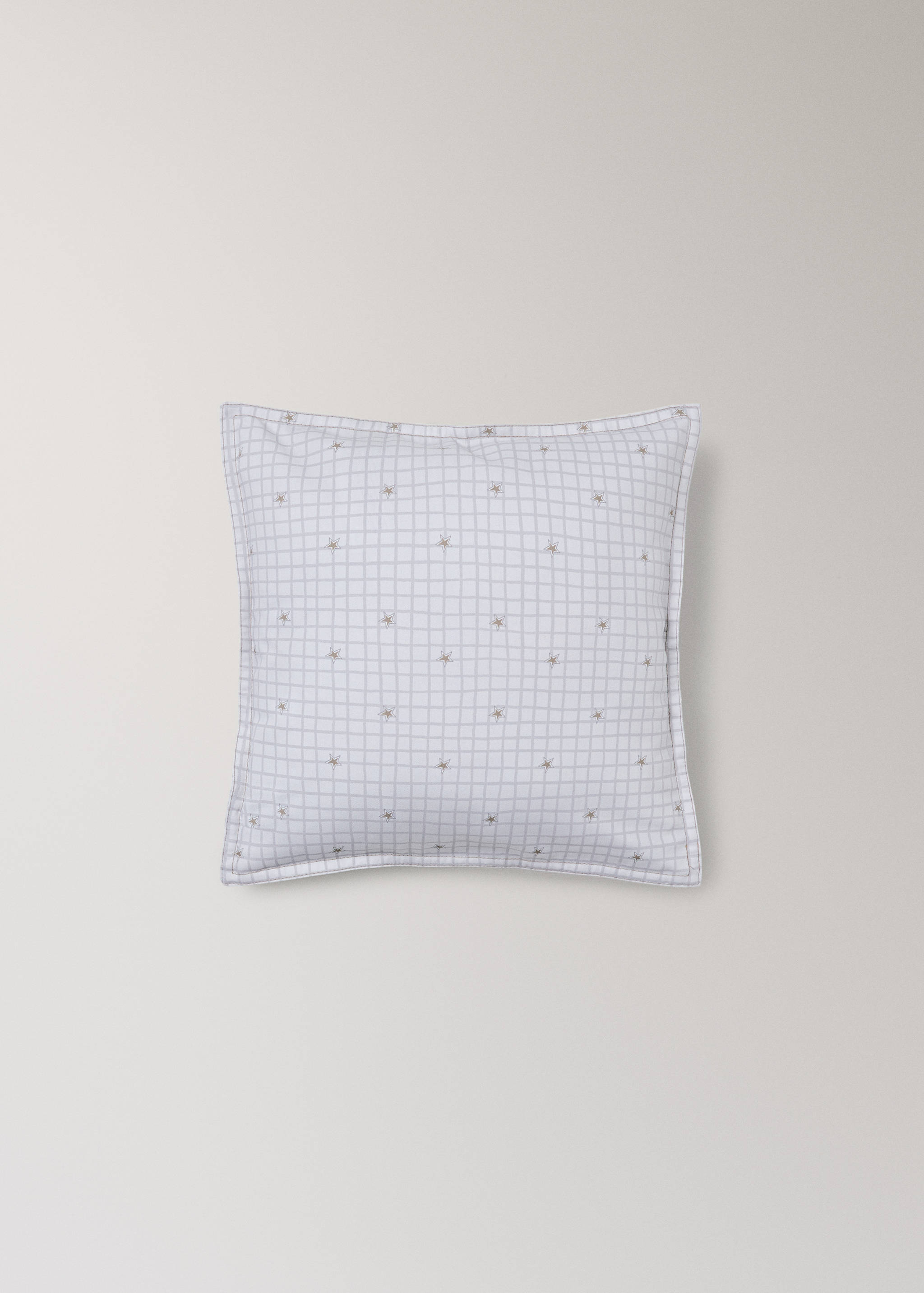White cushion cover with a fine grey grid pattern and small star embroidery.