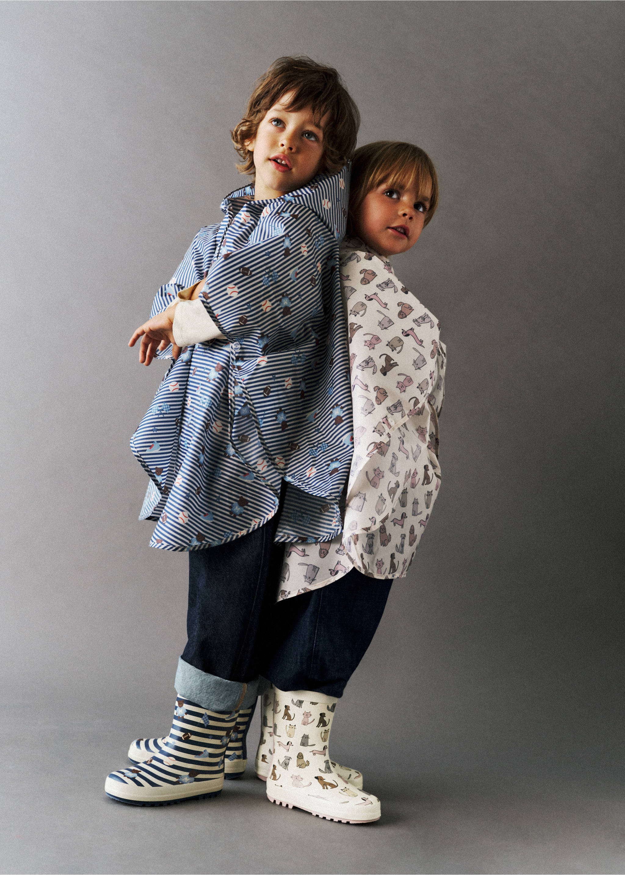 Striped rain boots worn by two models in matching rain capes., Pastel Pink. Ref: 37014780-00.