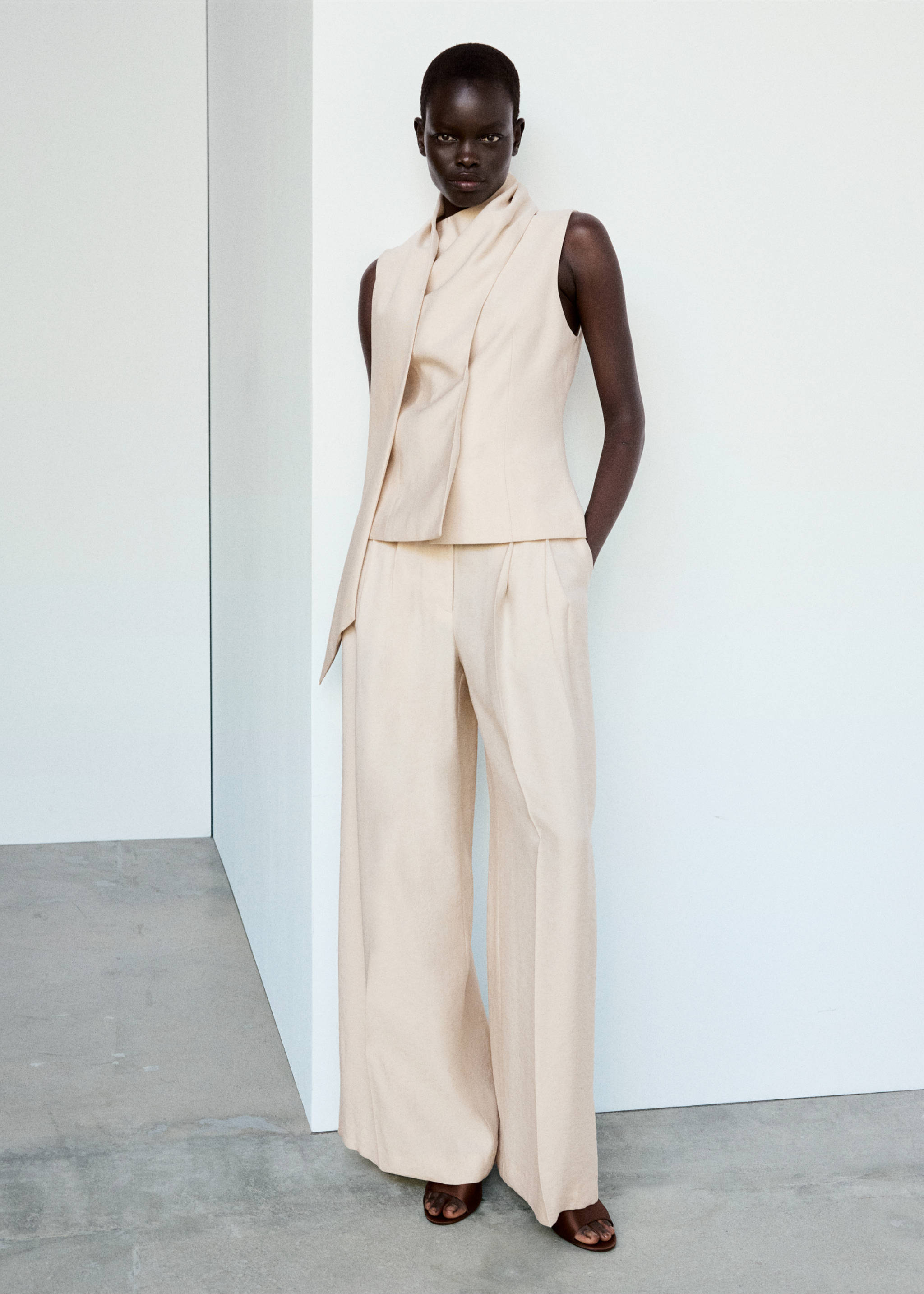 Cream sleeveless high-neck top with a draped scarf detail, worn with matching wide-leg trousers., Light/Pastel Grey. Ref: 37014803-01.