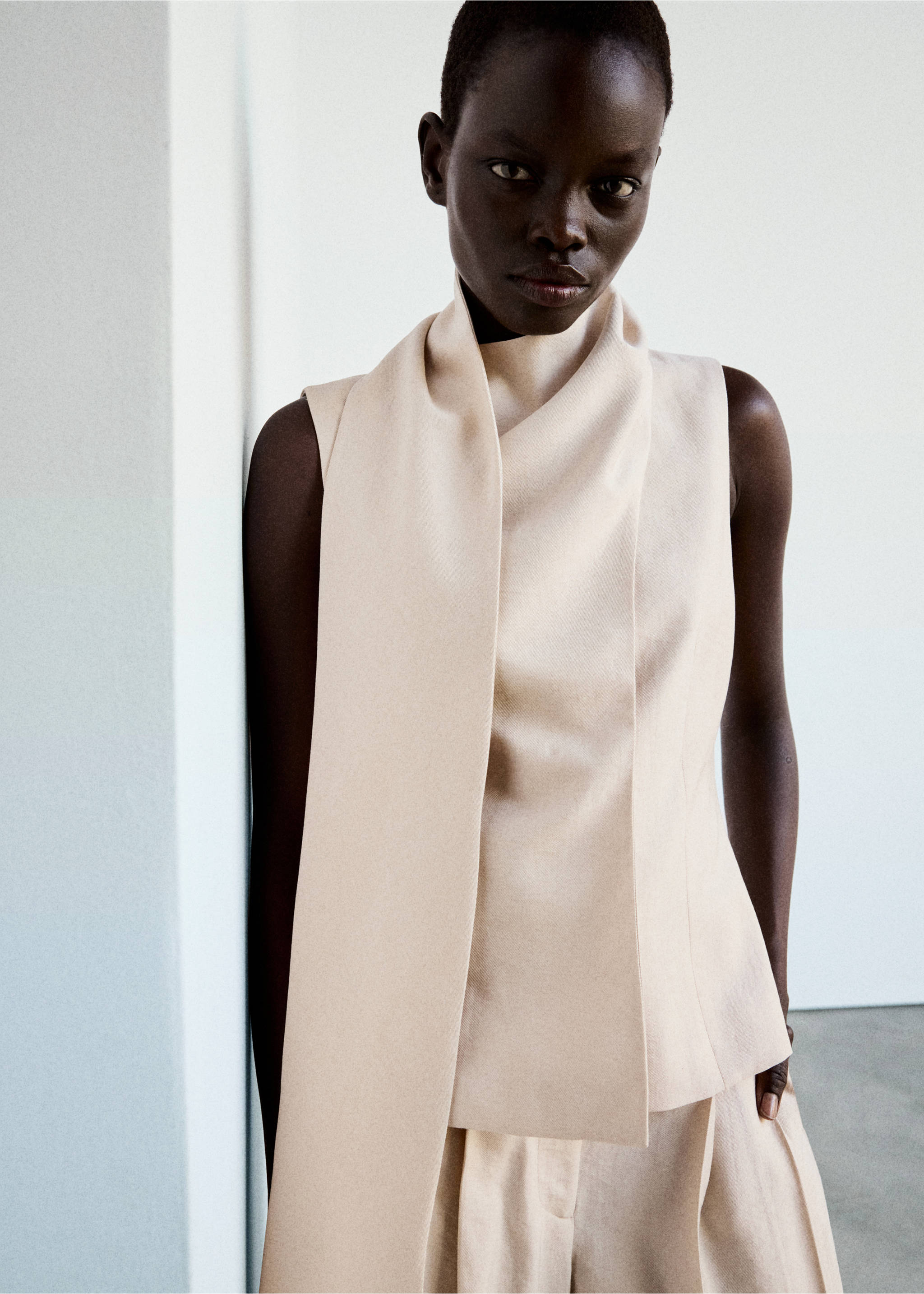 Sleeveless cream top with a high collar and draped front panel., Light/Pastel Grey. Ref: 37014803-01.