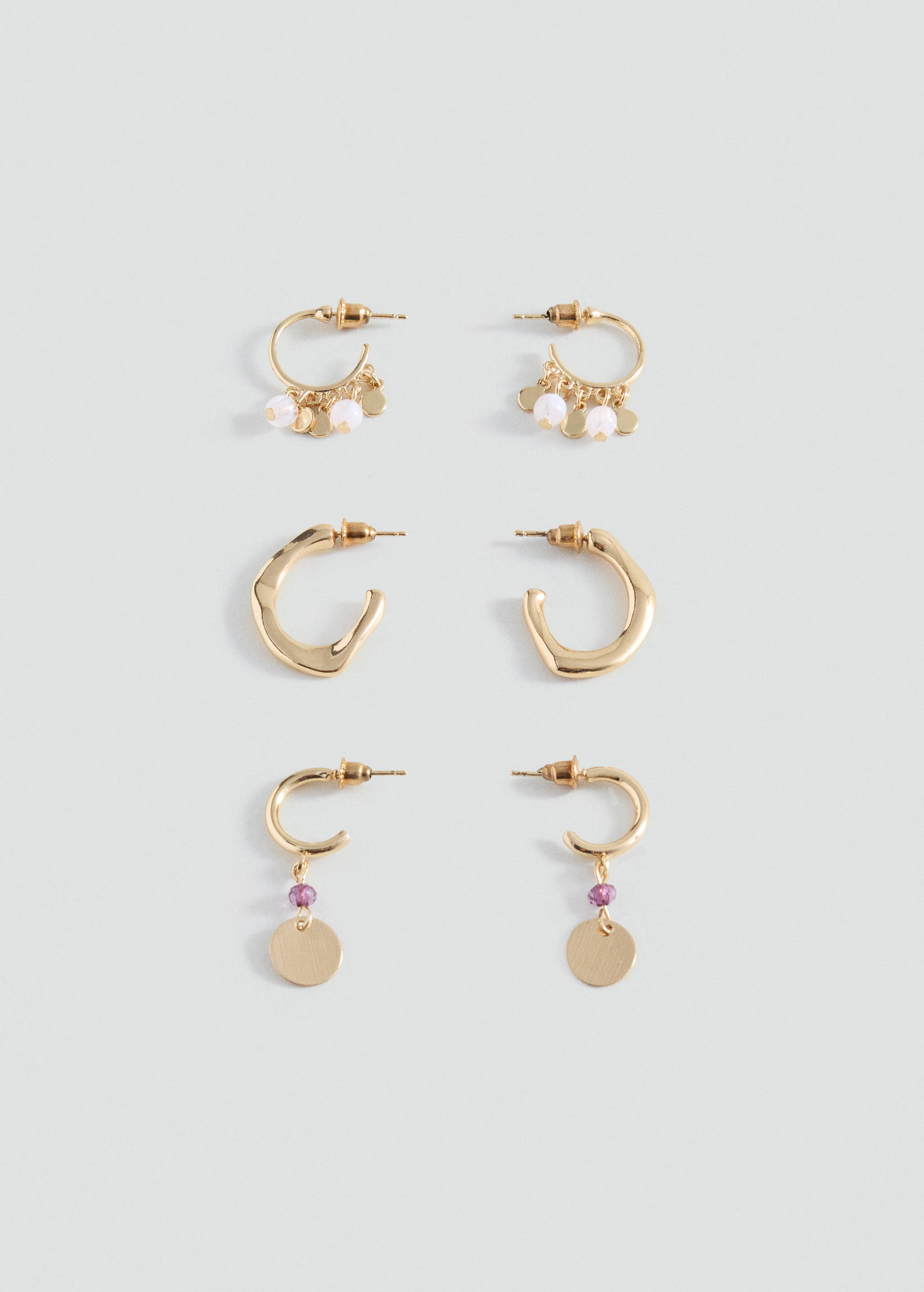 Set of three pairs of gold-finish earrings with beads and charms.