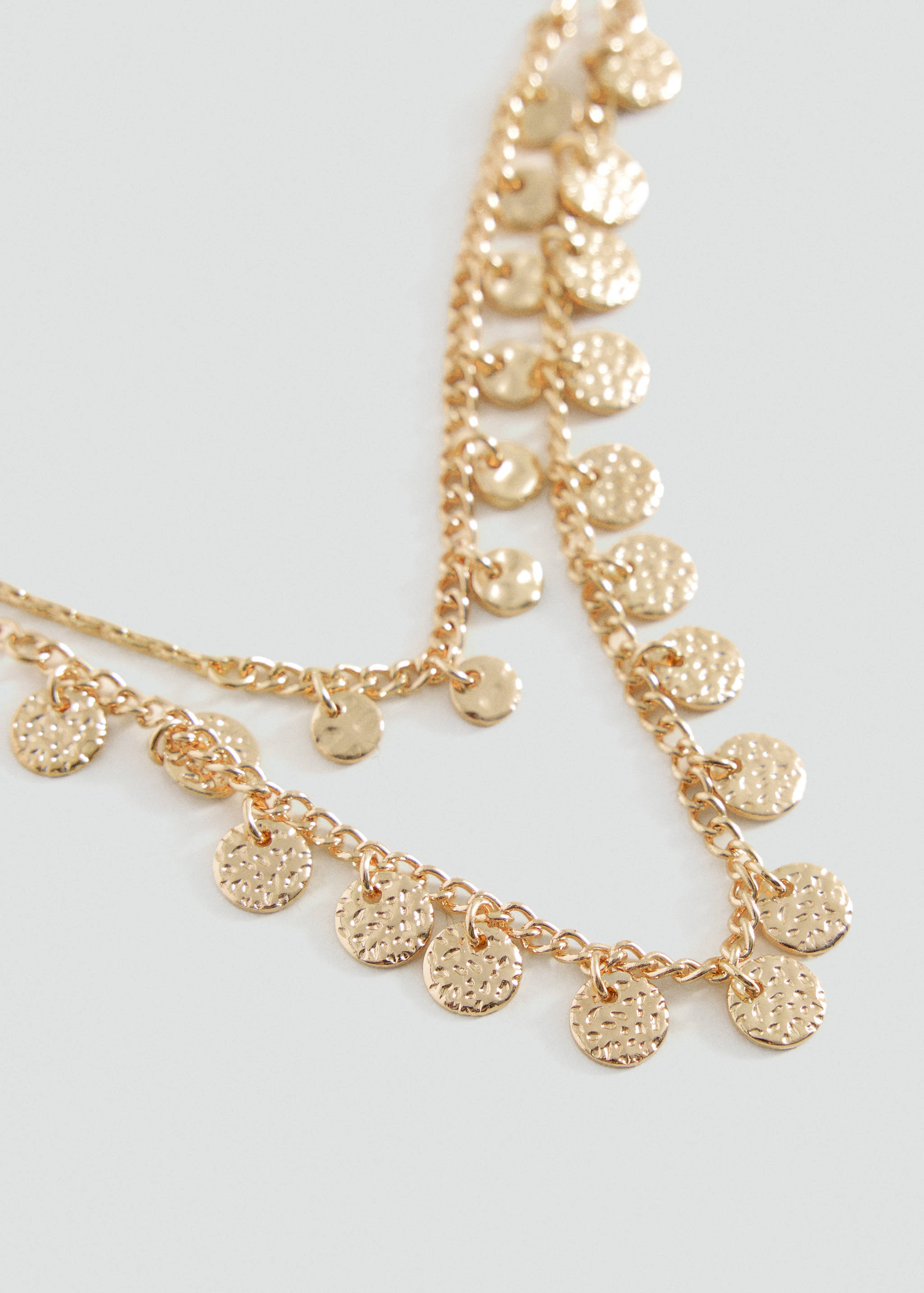 Gold multi-strand chain necklace with textured coin charms.